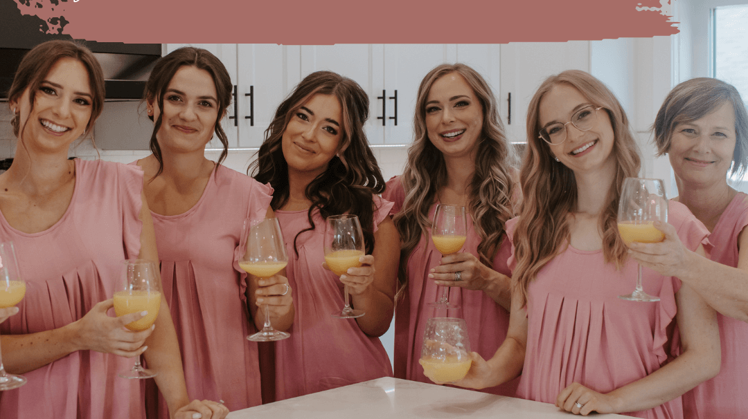 Bridal party in matching pink pajamas celebrating with drinks, highlighting the importance of coordinating outfits.