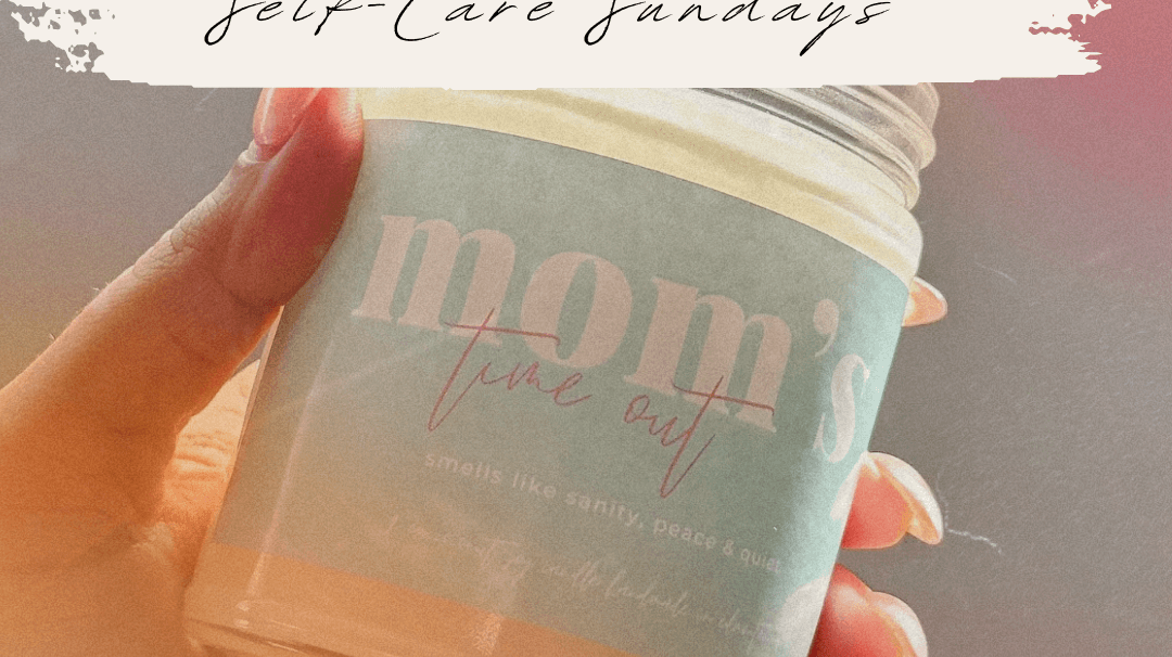 A hand holding a scented candle labeled "mom's time out" perfect for self-care Sundays.