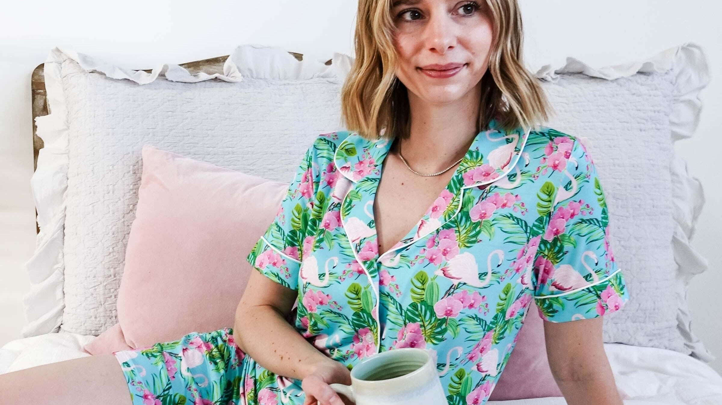 Spring 2026 Sleepwear Trends featuring a woman in tropical-themed pajamas with a cup.