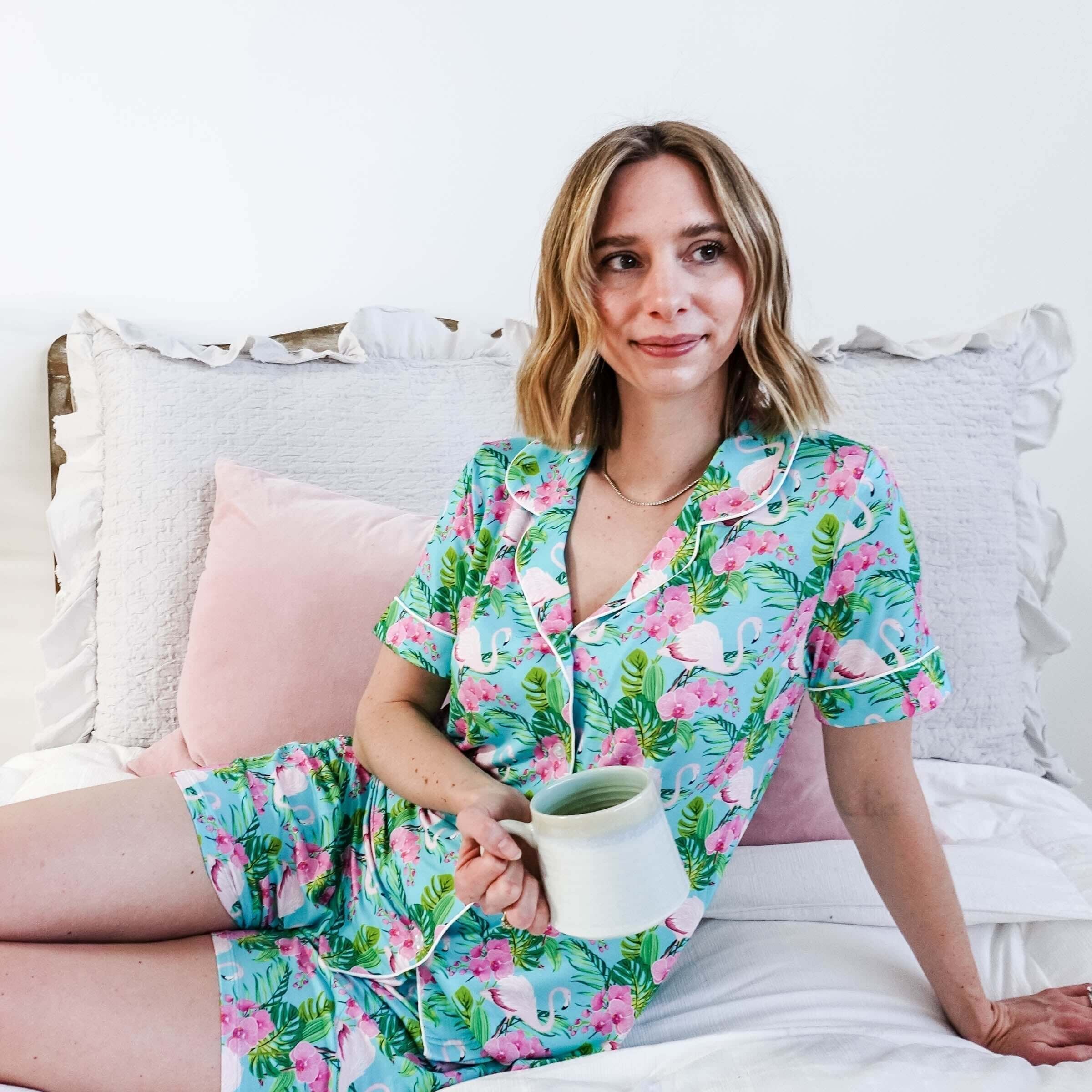 Spring 2026 Sleepwear Trends featuring a woman in tropical-themed pajamas with a cup.