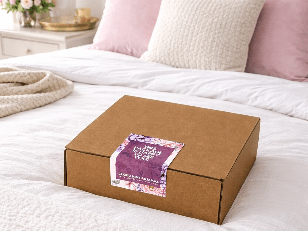 Spring 2026 Seasonal Box on a cozy bed with decorative pillows and soft bedding.