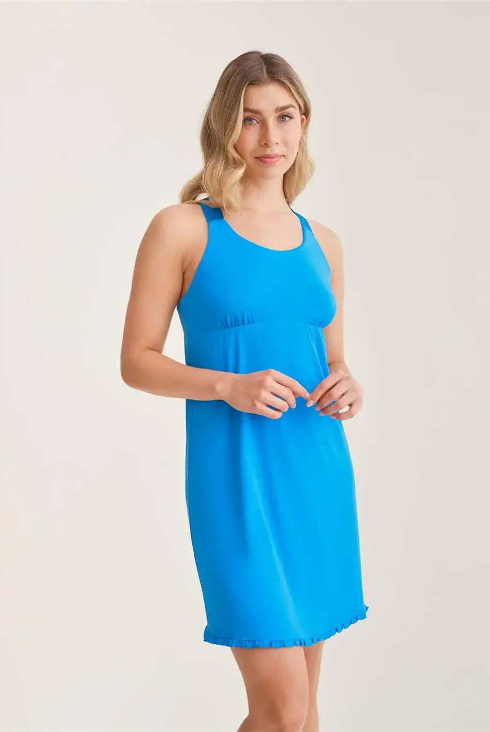 Fleurt by Montelle Racerback Nightshirt - Built-In Support in True Blue. Shown on model who is standing against a plain background