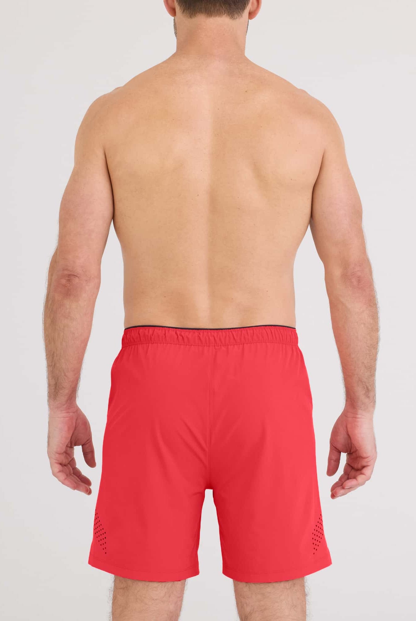 Back view of a man wearing Power Moves 2N1 Short 7 in red, showcasing the fit and design for athletic performance.