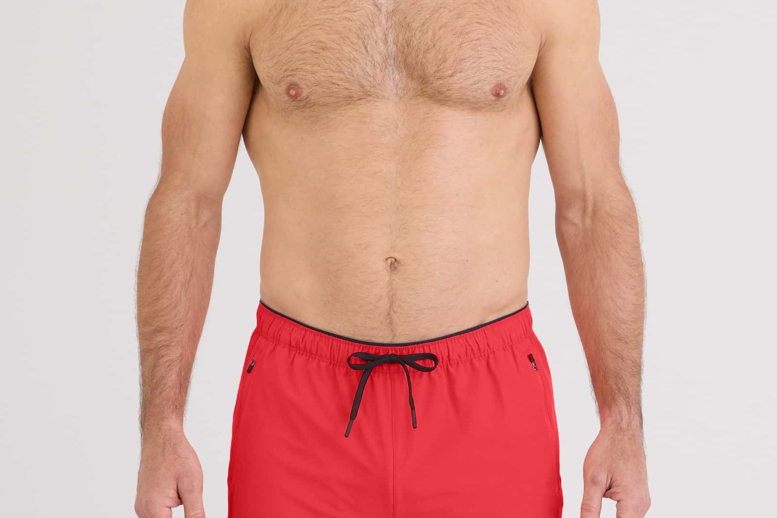 Model wearing red Power Moves 2N1 Short 7 for active training, showcasing the 4-way stretch design.