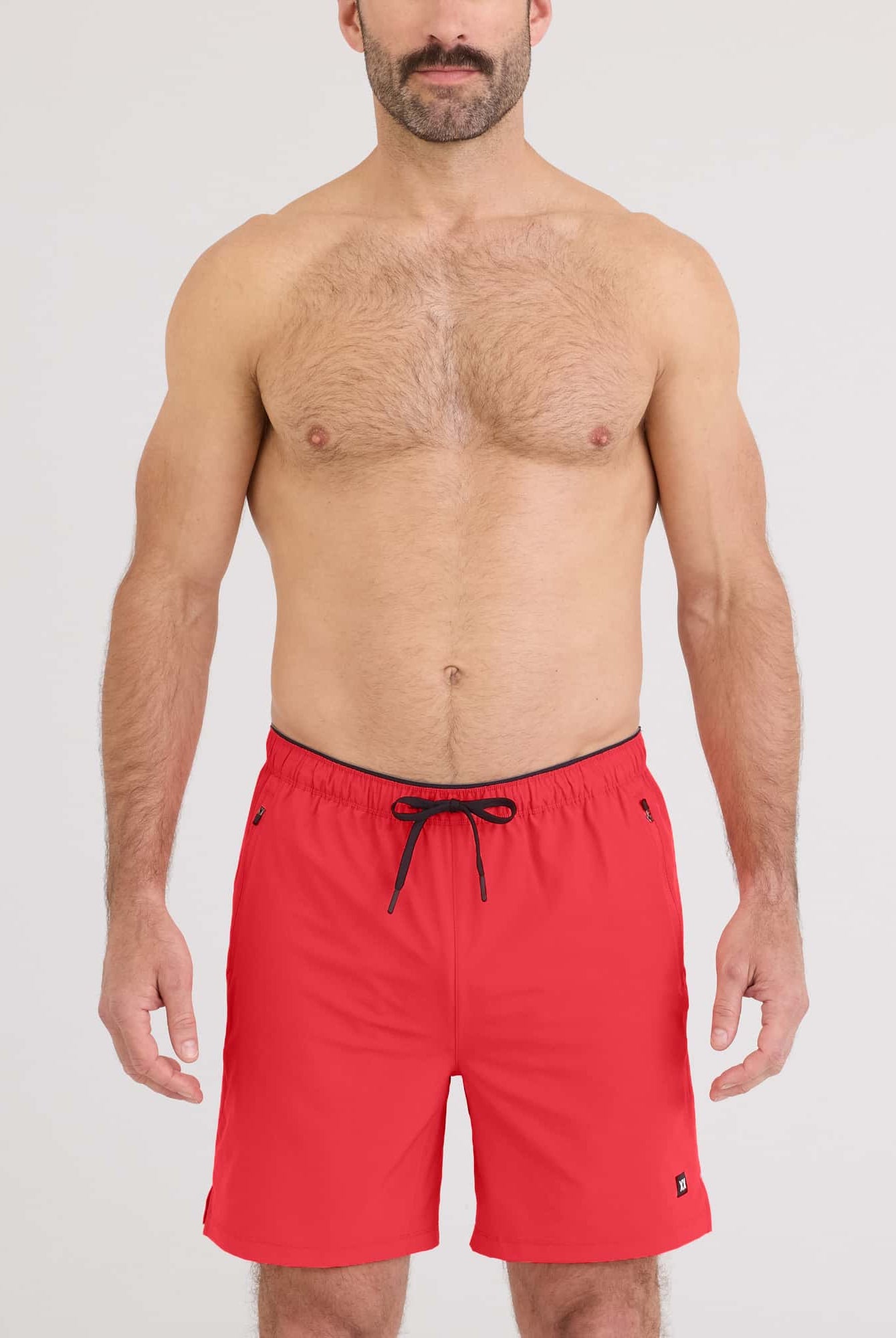 Model wearing red Power Moves 2N1 Short 7 for active training, showcasing the 4-way stretch design.