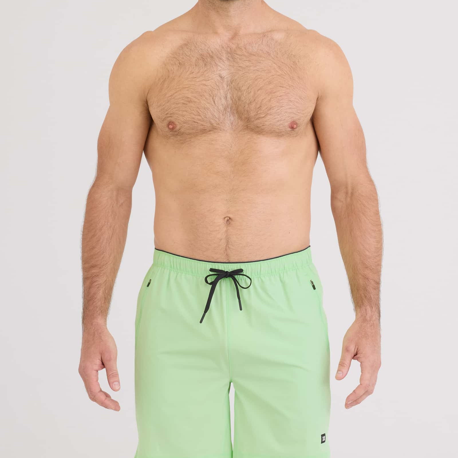 Man wearing Power Moves 2N1 Short 7 in mint green, showcasing comfort and performance for active lifestyles.