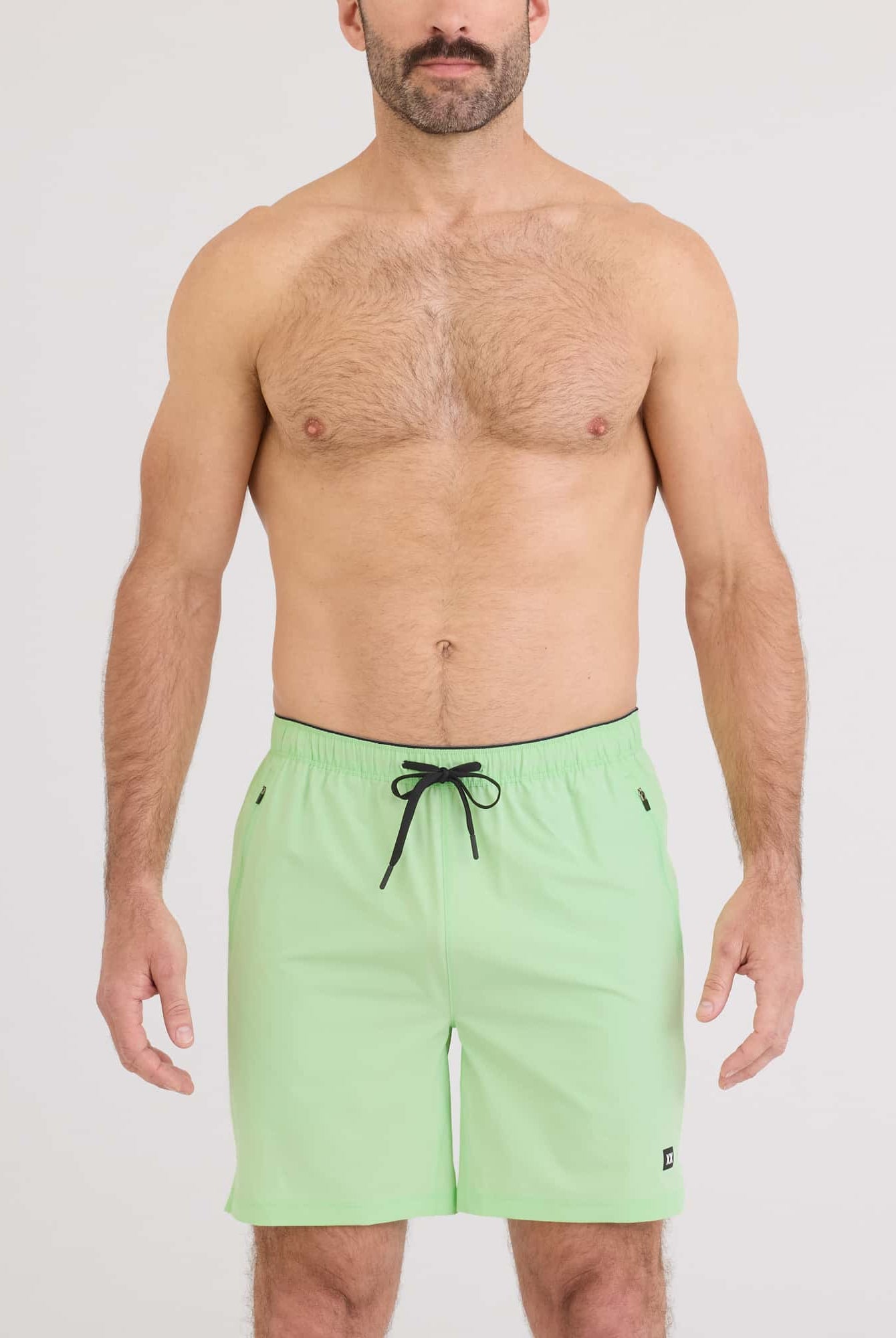 Man wearing Power Moves 2N1 Short 7 in mint green, showcasing comfort and performance for active lifestyles.