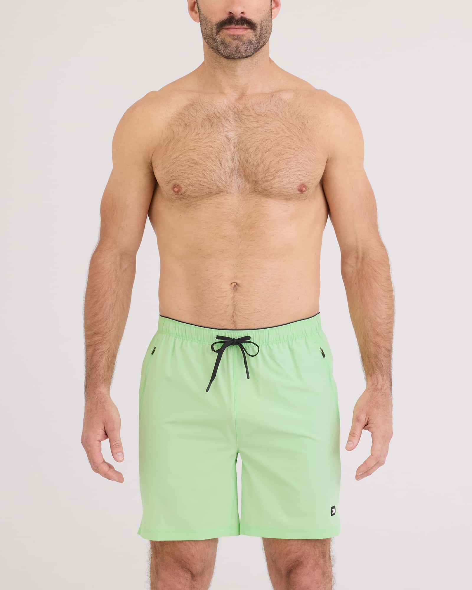 Man wearing Power Moves 2N1 Short 7 in mint green, showcasing comfort and performance for active lifestyles.