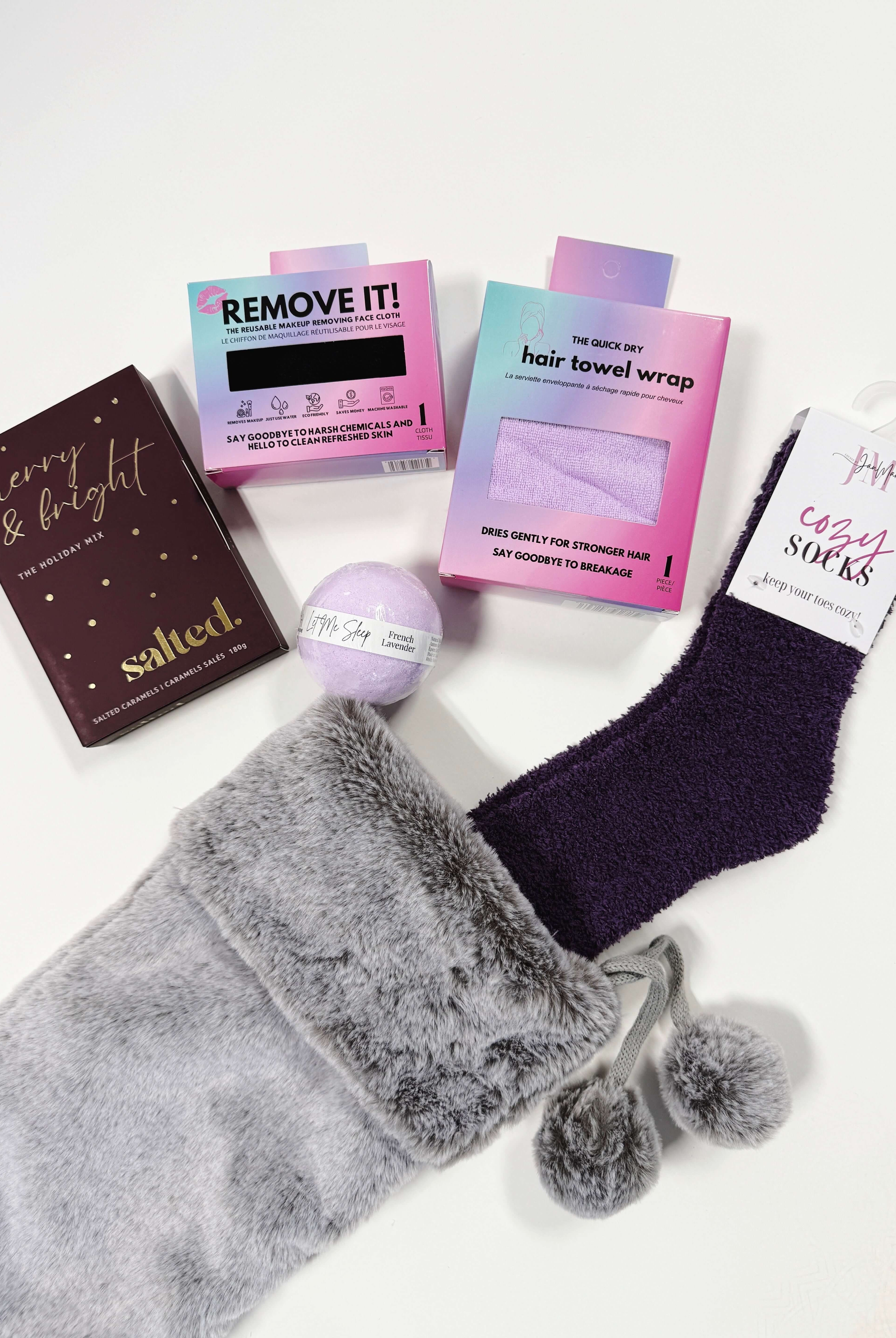 Little Luxuries Stocking Gift Set with gray stocking, cozy socks, hair towel wrap, and spa products.