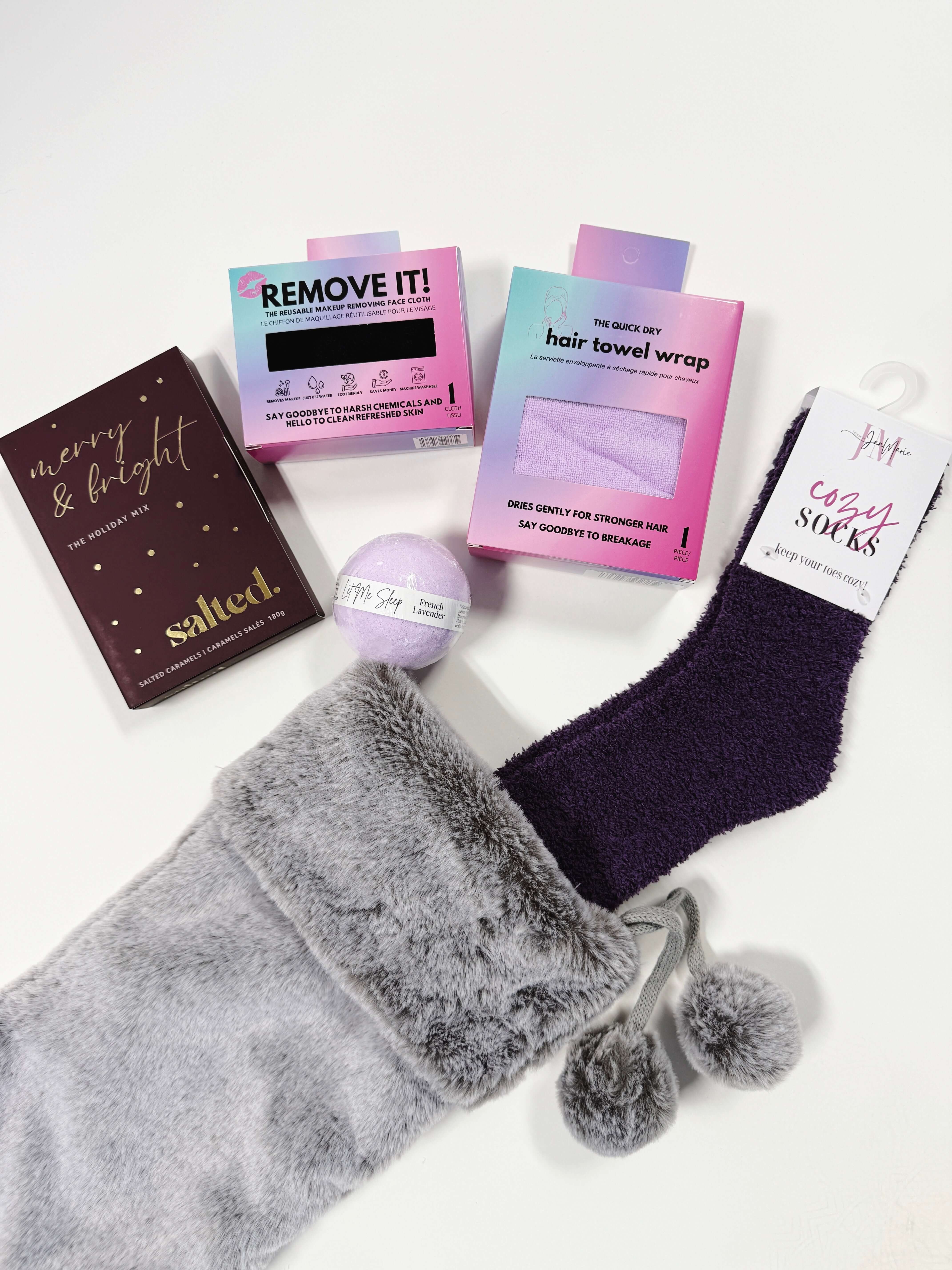 Little Luxuries Stocking Gift Set with gray stocking, cozy socks, hair towel wrap, and spa products.