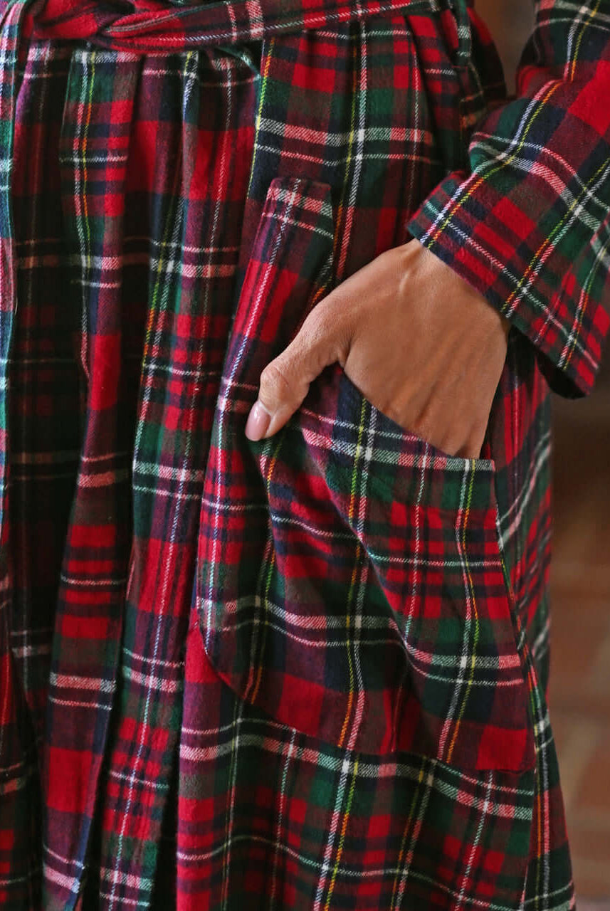 Close-up of the Yuletide Check Dressing Gown featuring red plaid flannel and hand in pocket.
