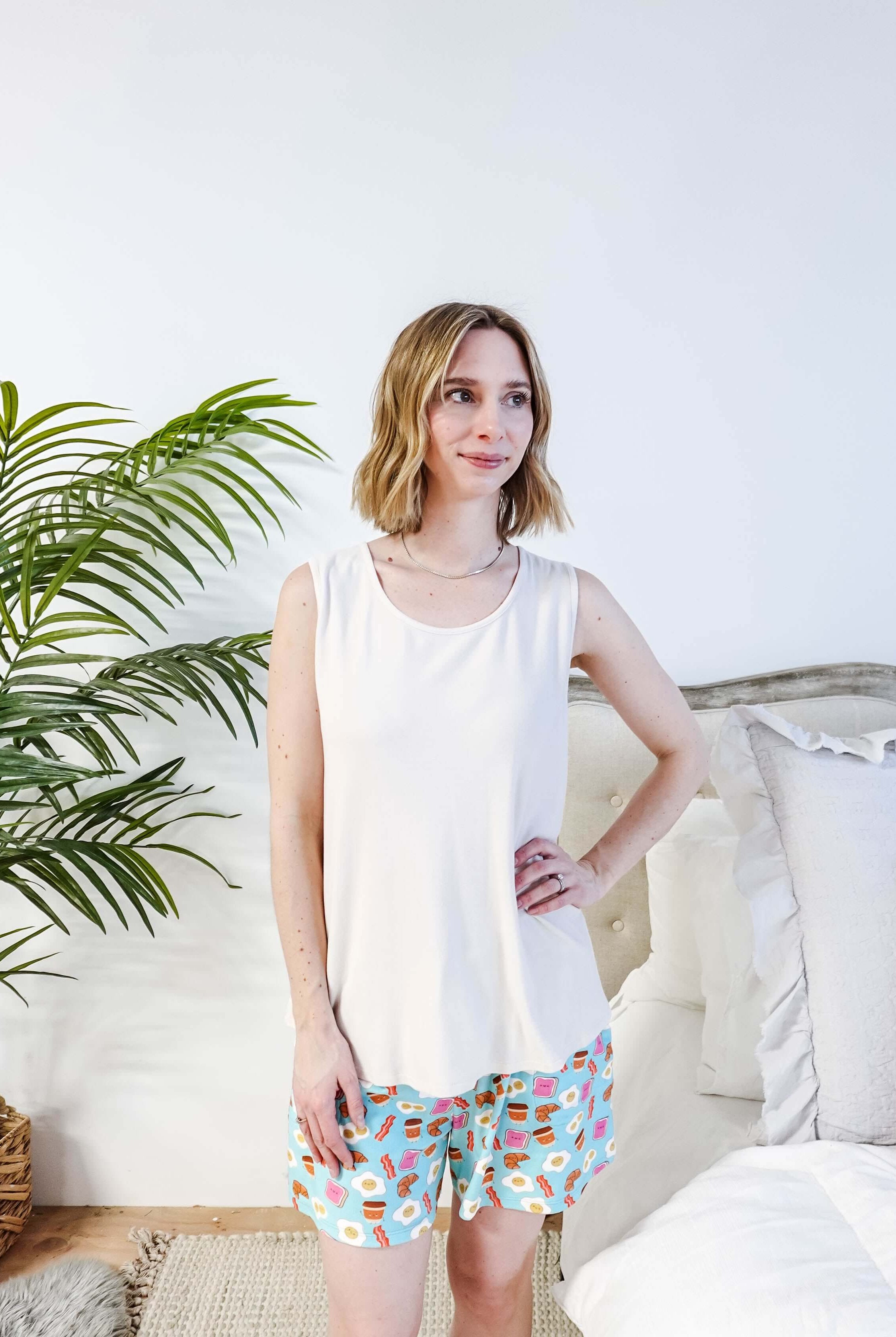 Front View of Miranda wearing the Brunch Club velour shorts with eggs and bacon print and ivory peachy tank.