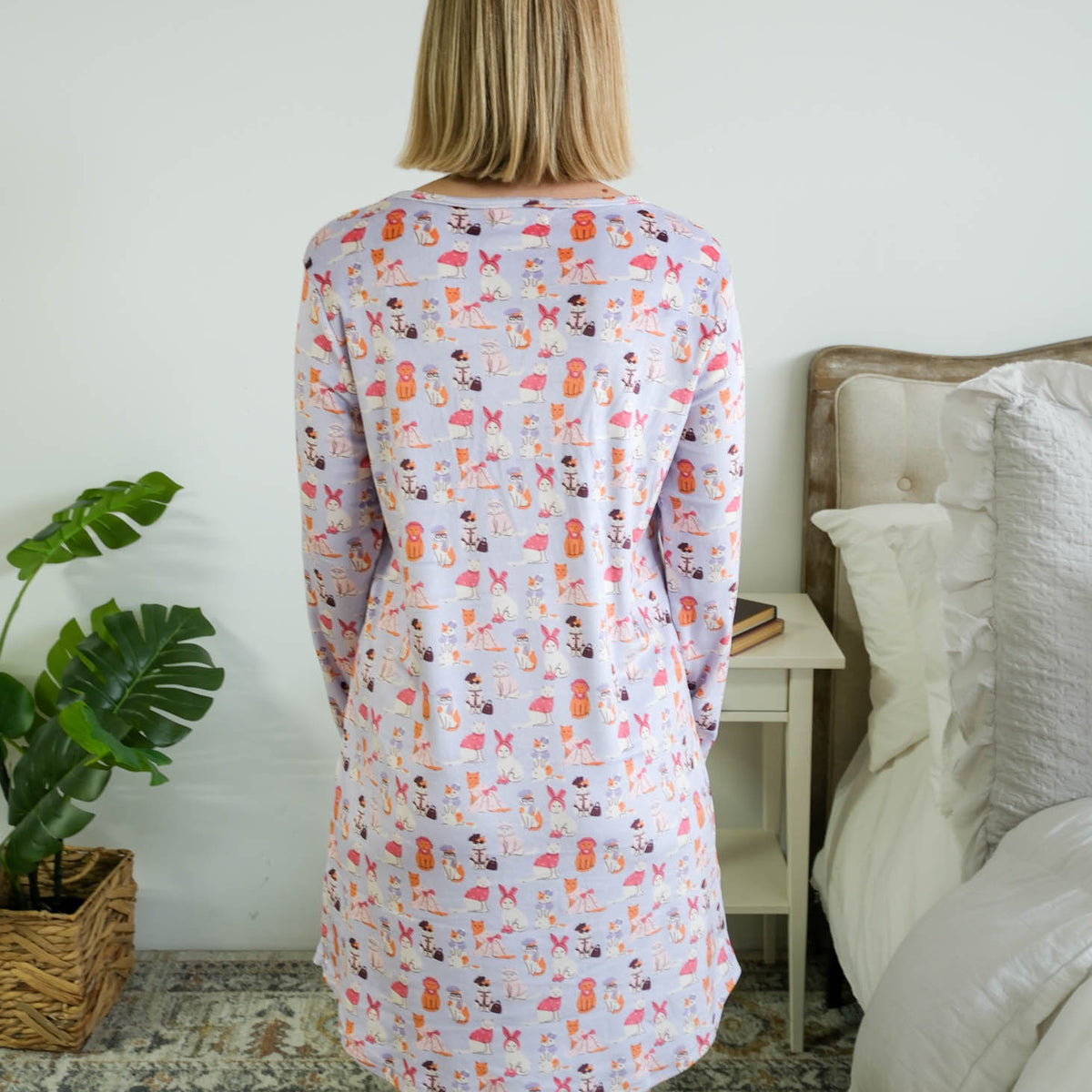 Full length back view on a model of the Miranda Nic women's purple velour long sleeve nightshirt sleep dress featuring Catwalk Kitties print - Cloud Nine Pajamas.