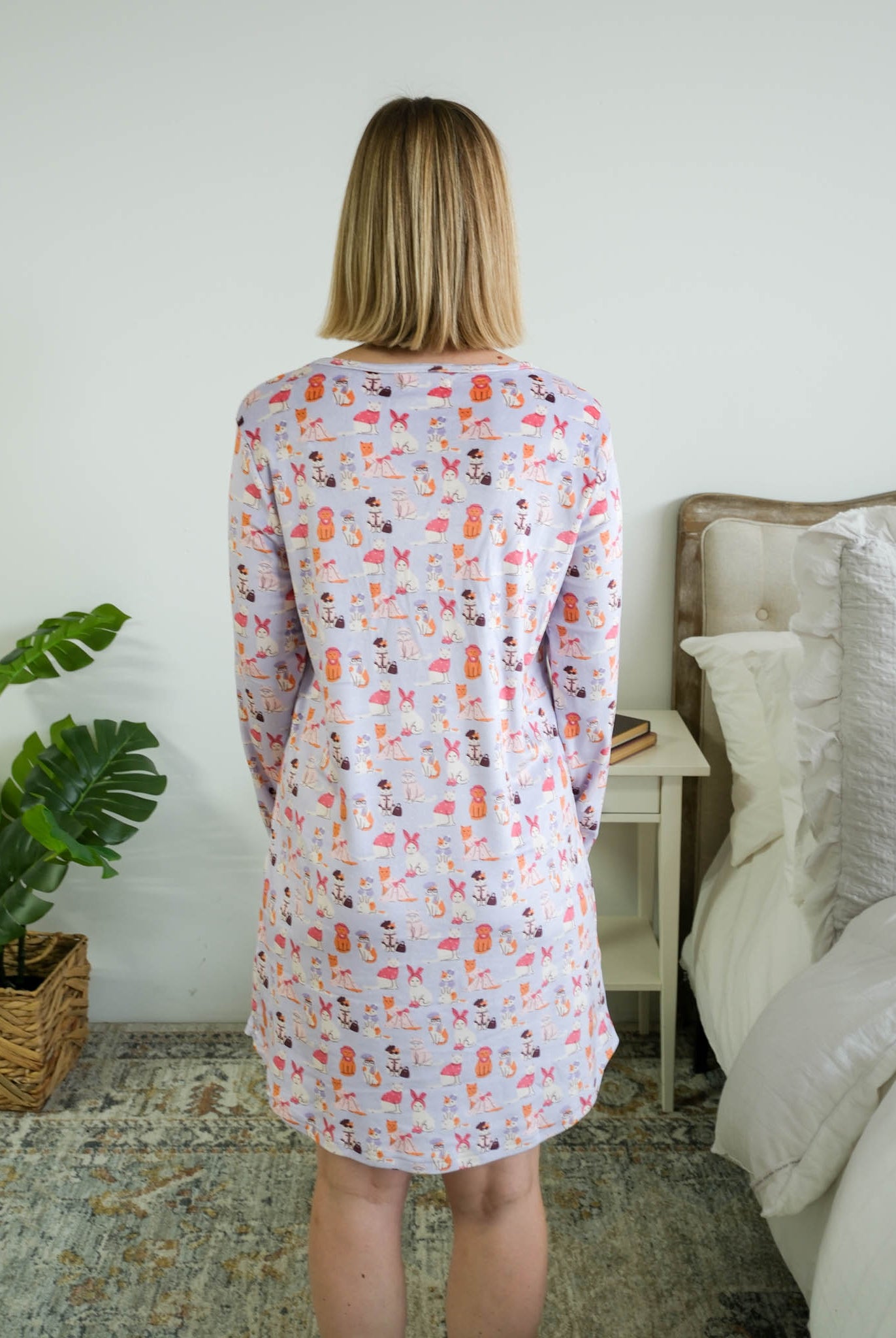 Full length back view on a model of the Miranda Nic women's purple velour long sleeve nightshirt sleep dress featuring Catwalk Kitties print - Cloud Nine Pajamas.