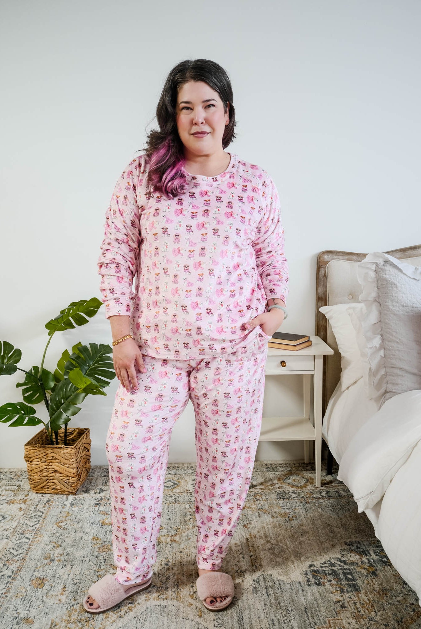 Plus size model full length standing shot of the Miranda Nic women's pink velour long sleeve top and jogger pants loungewear set featuring Chic Puppies dog print