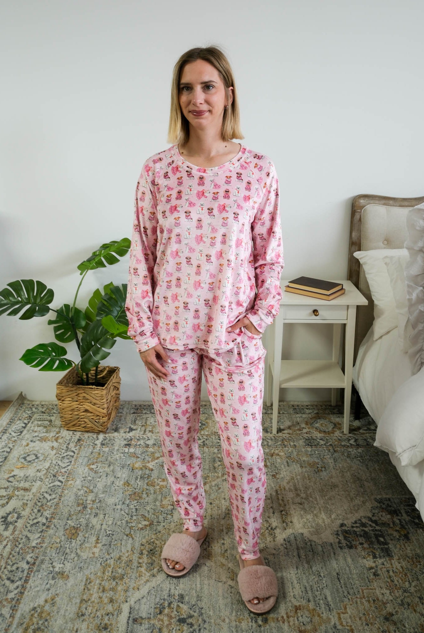 Full length photo of Miranda Nic women's pink velour long sleeve top and jogger pants loungewear set featuring Chic Puppies dog print