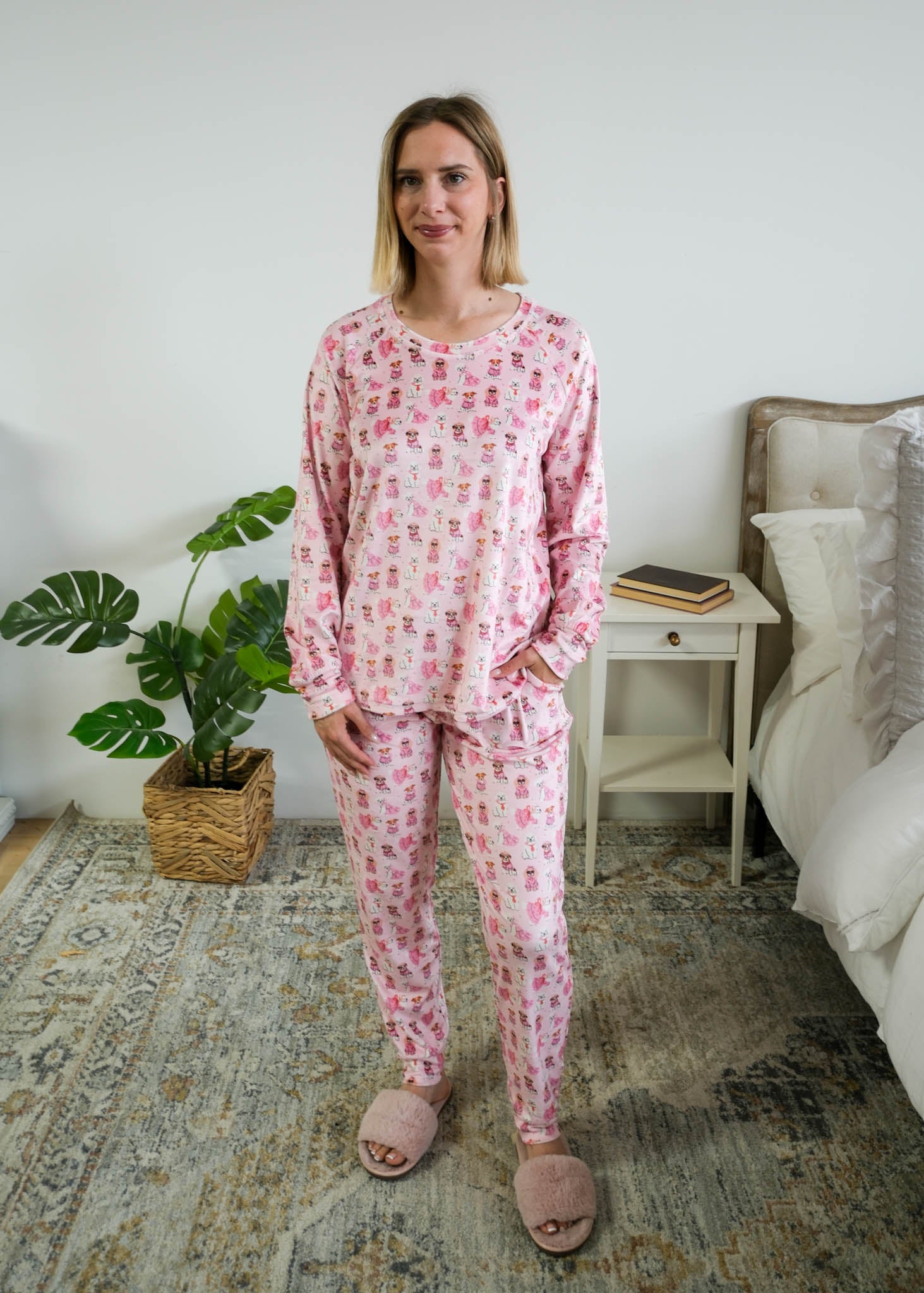 Full length photo of Miranda Nic women's pink velour long sleeve top and jogger pants loungewear set featuring Chic Puppies dog print