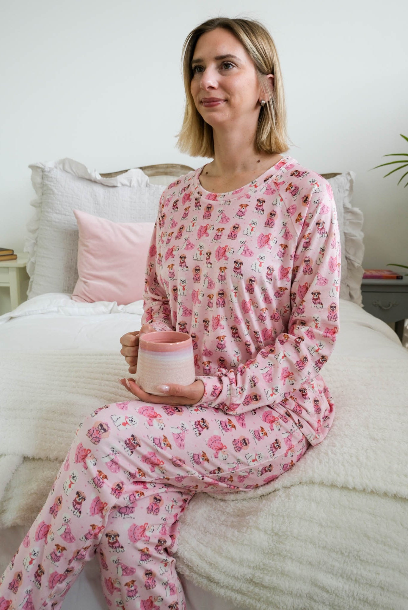 lifestyle photo on model of Miranda Nic women's pink velour long sleeve top and jogger pants loungewear set featuring Chic Puppies dog print - Cloud Nine Pajamas