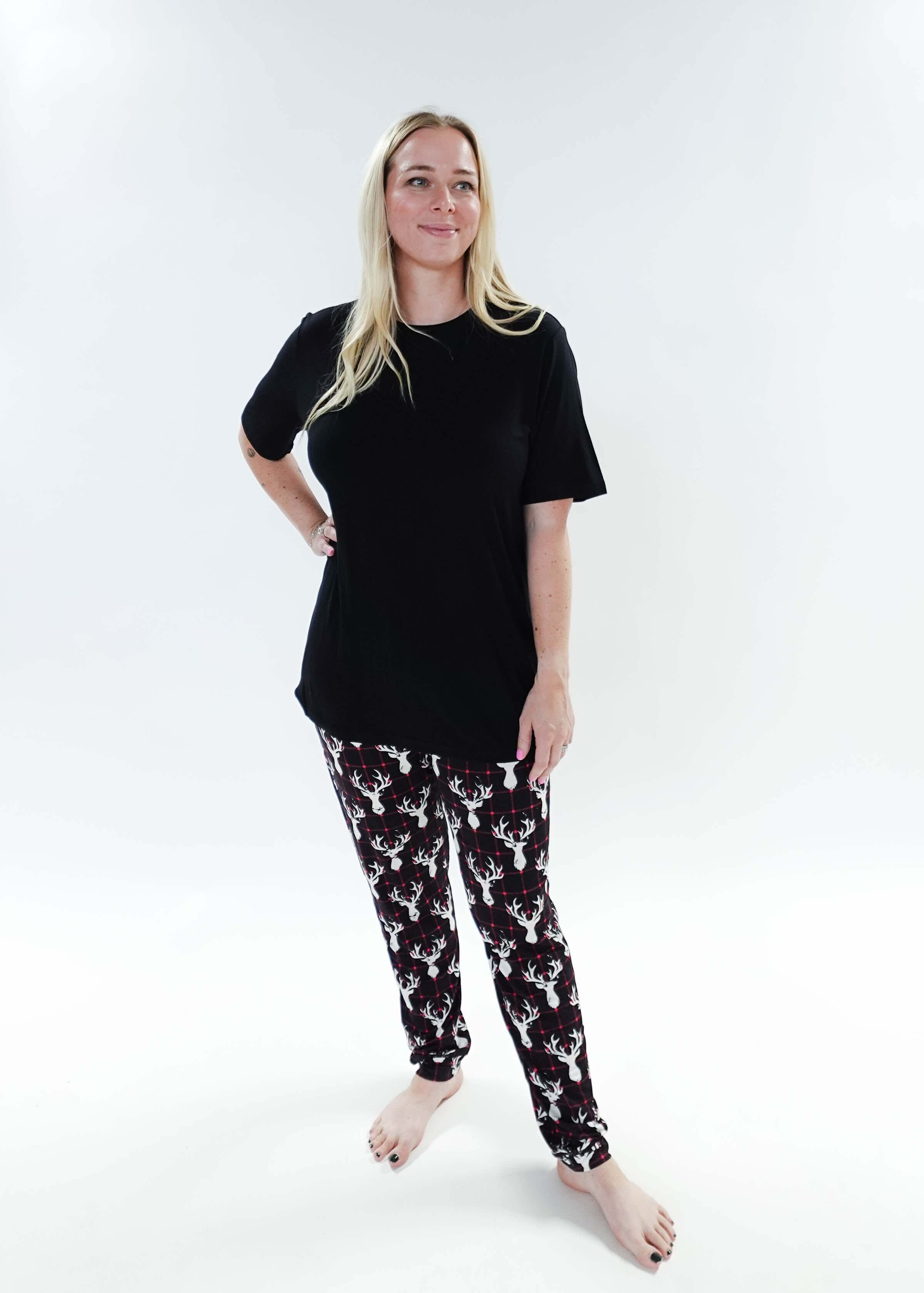 Woman wearing Deer Plaid Unisex Bamboo Jogger and a black top, showcasing comfort and style in sleepwear.
