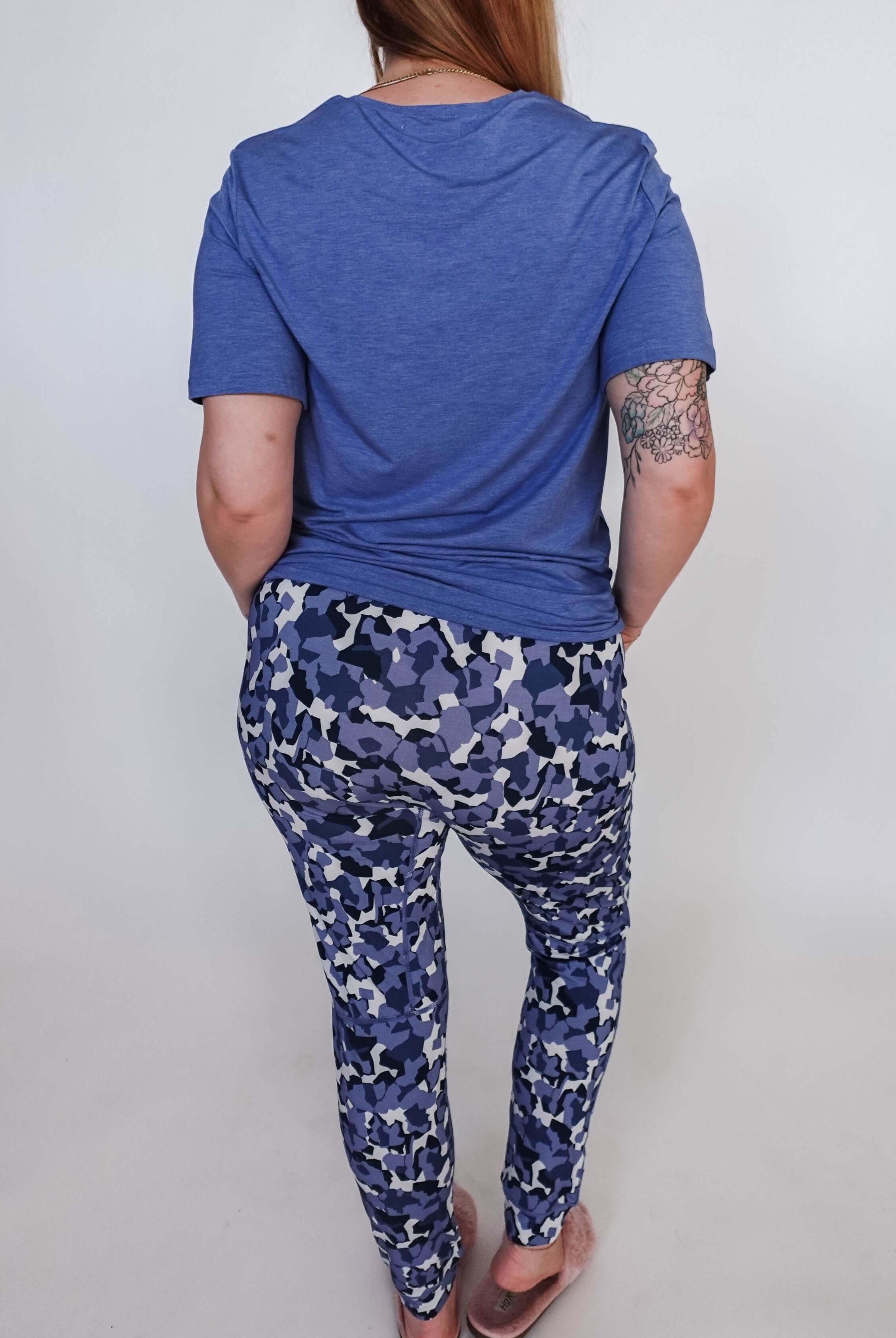 Woman wearing Geo Camo Print Unisex Jogger Pant Bamboo with a blue t-shirt, showing the back view.