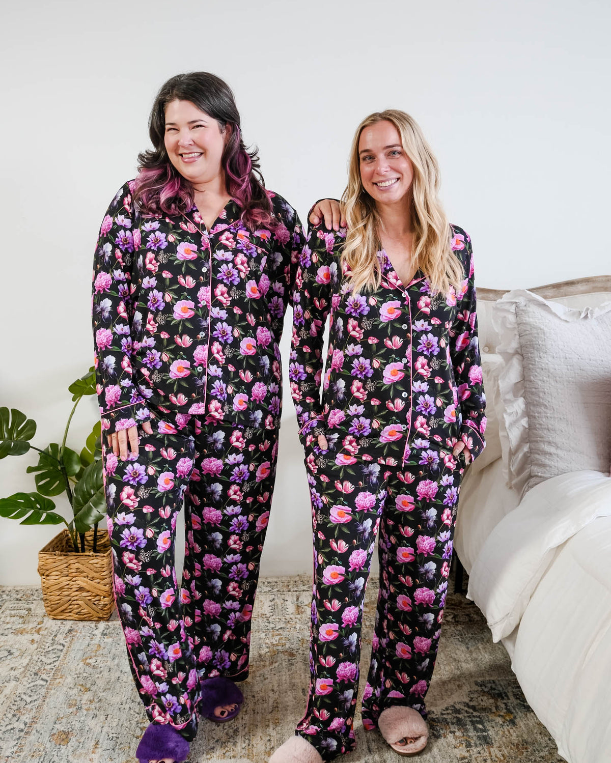 Georgia Rylan women's bamboo long sleeve button-up top and straight-leg pajama pants in Dreamy Blooms black floral print - Cloud Nine Pajamas on models in a bedroom setting