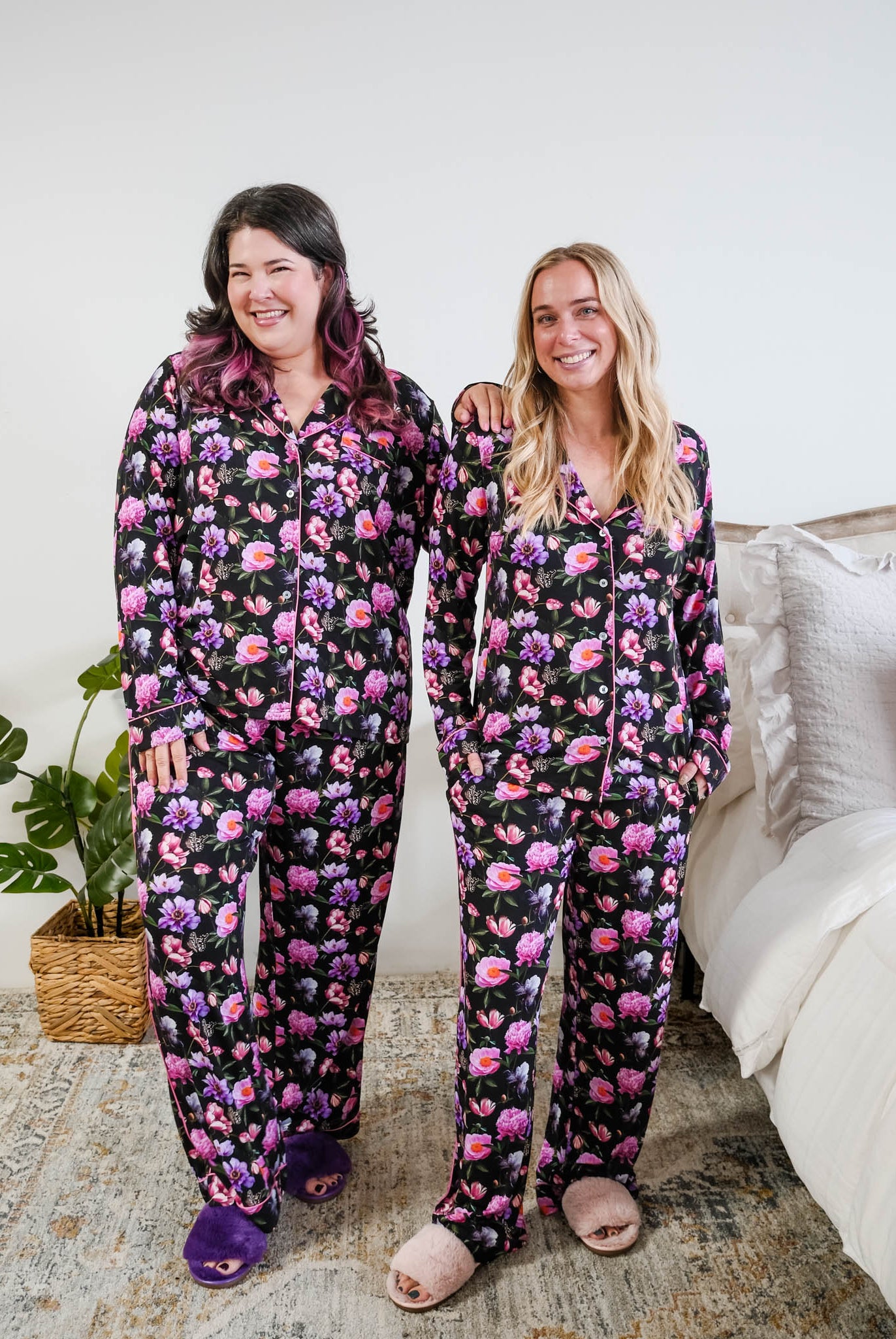 Georgia Rylan women's bamboo long sleeve button-up top and straight-leg pajama pants in Dreamy Blooms black floral print - Cloud Nine Pajamas on models in a bedroom setting