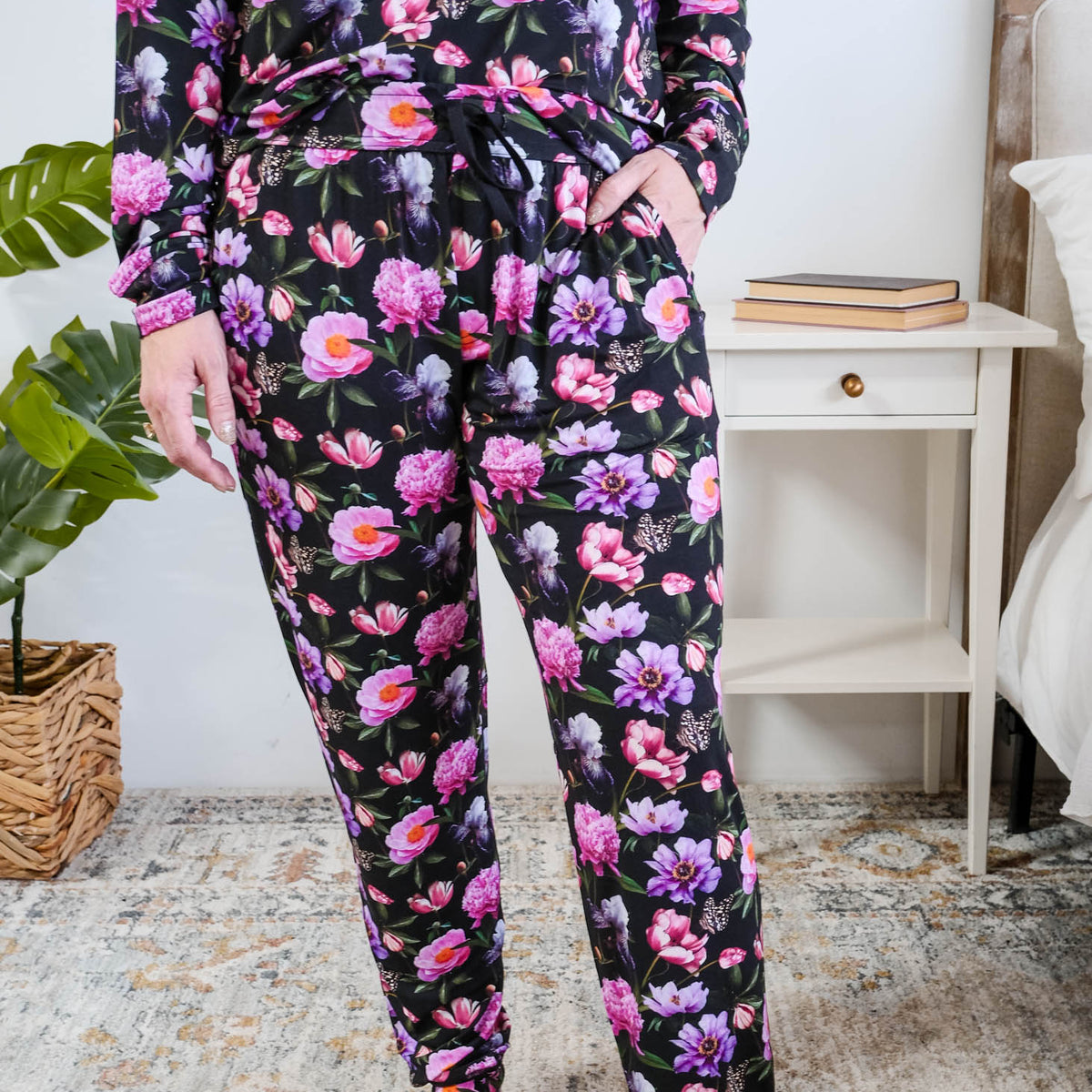 Georgia Rylan women's long sleeve crewneck top and jogger pajama pants set in Dreamy Blooms black floral bamboo Cloud Nine Pajamas showing hand in pocket and jogger print detail
