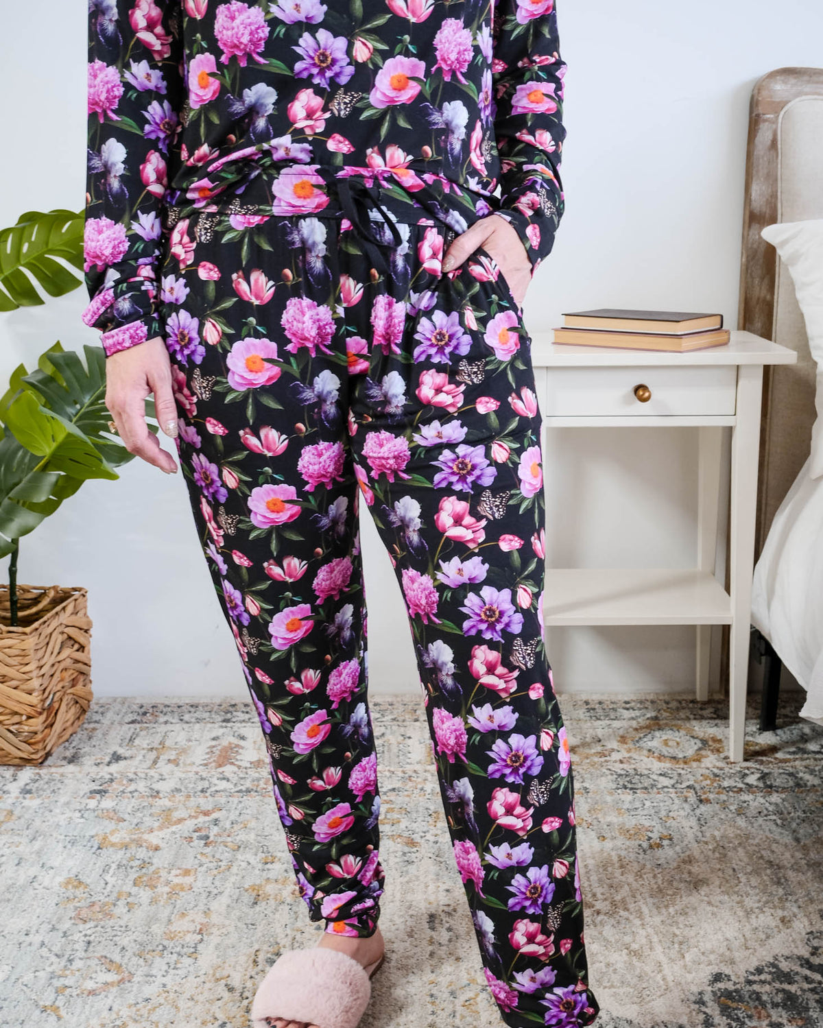 Georgia Rylan women's long sleeve crewneck top and jogger pajama pants set in Dreamy Blooms black floral bamboo Cloud Nine Pajamas showing hand in pocket and jogger print detail