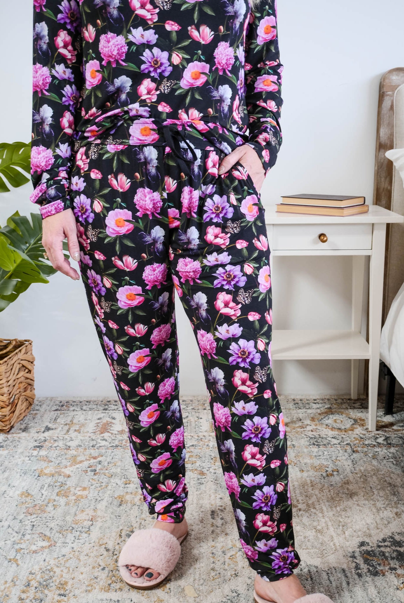 Georgia Rylan women's long sleeve crewneck top and jogger pajama pants set in Dreamy Blooms black floral bamboo Cloud Nine Pajamas showing hand in pocket and jogger print detail