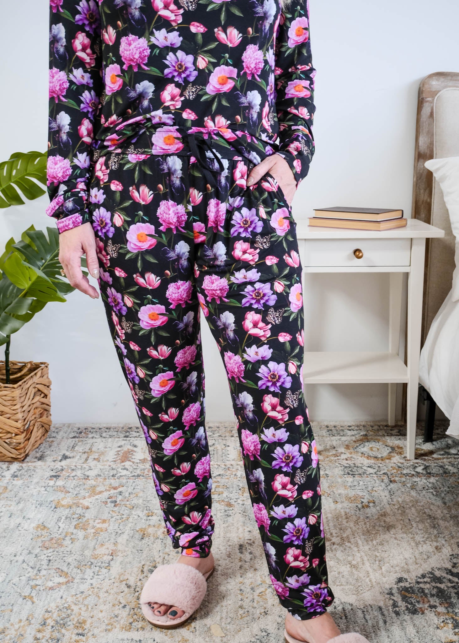 Georgia Rylan women's long sleeve crewneck top and jogger pajama pants set in Dreamy Blooms black floral bamboo Cloud Nine Pajamas showing hand in pocket and jogger print detail