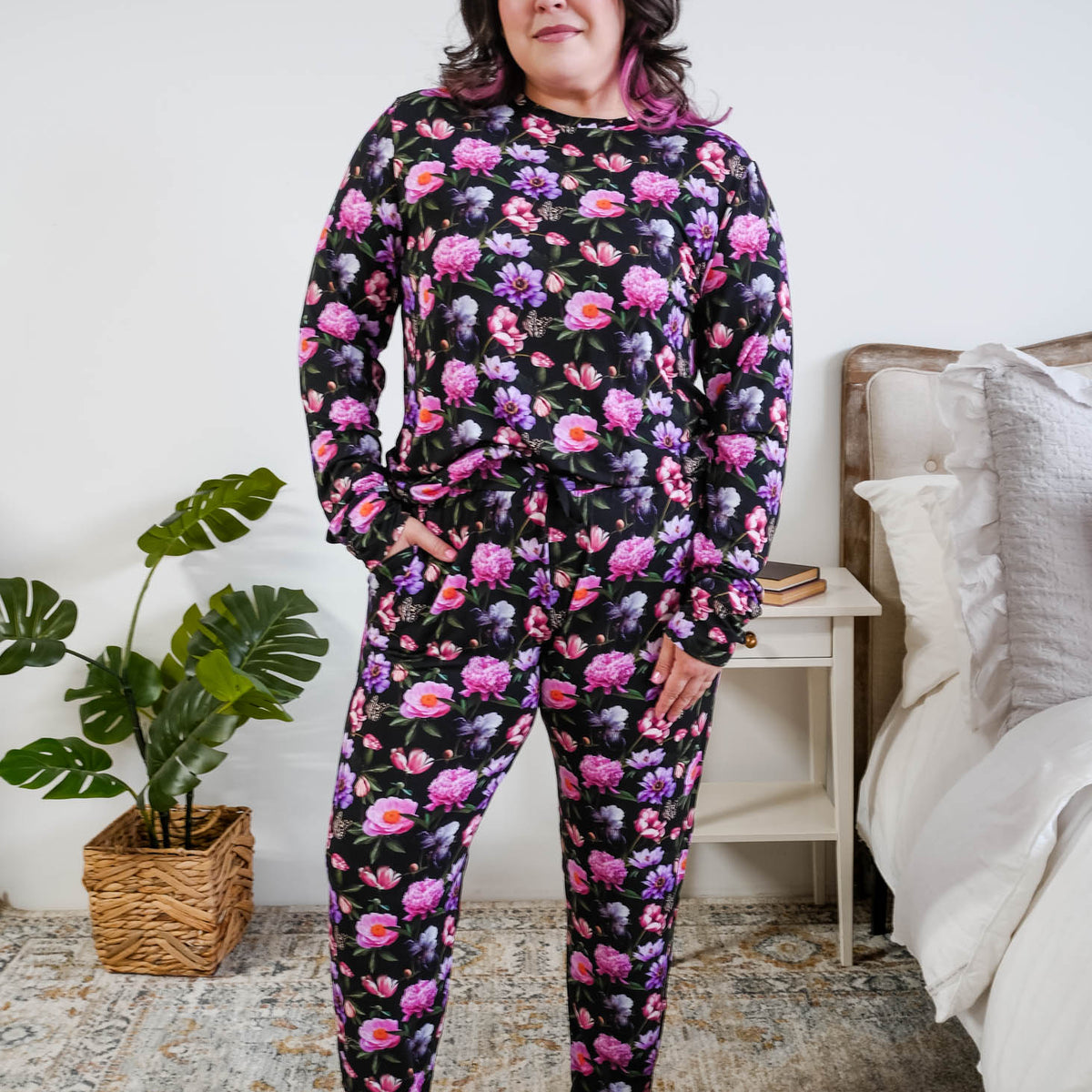 Tucked in view of the pyjama set on a plus size model full length Georgia Rylan women's long sleeve crewneck top and jogger pajama pants set in Dreamy Blooms black floral bamboo Cloud Nine Pajamas