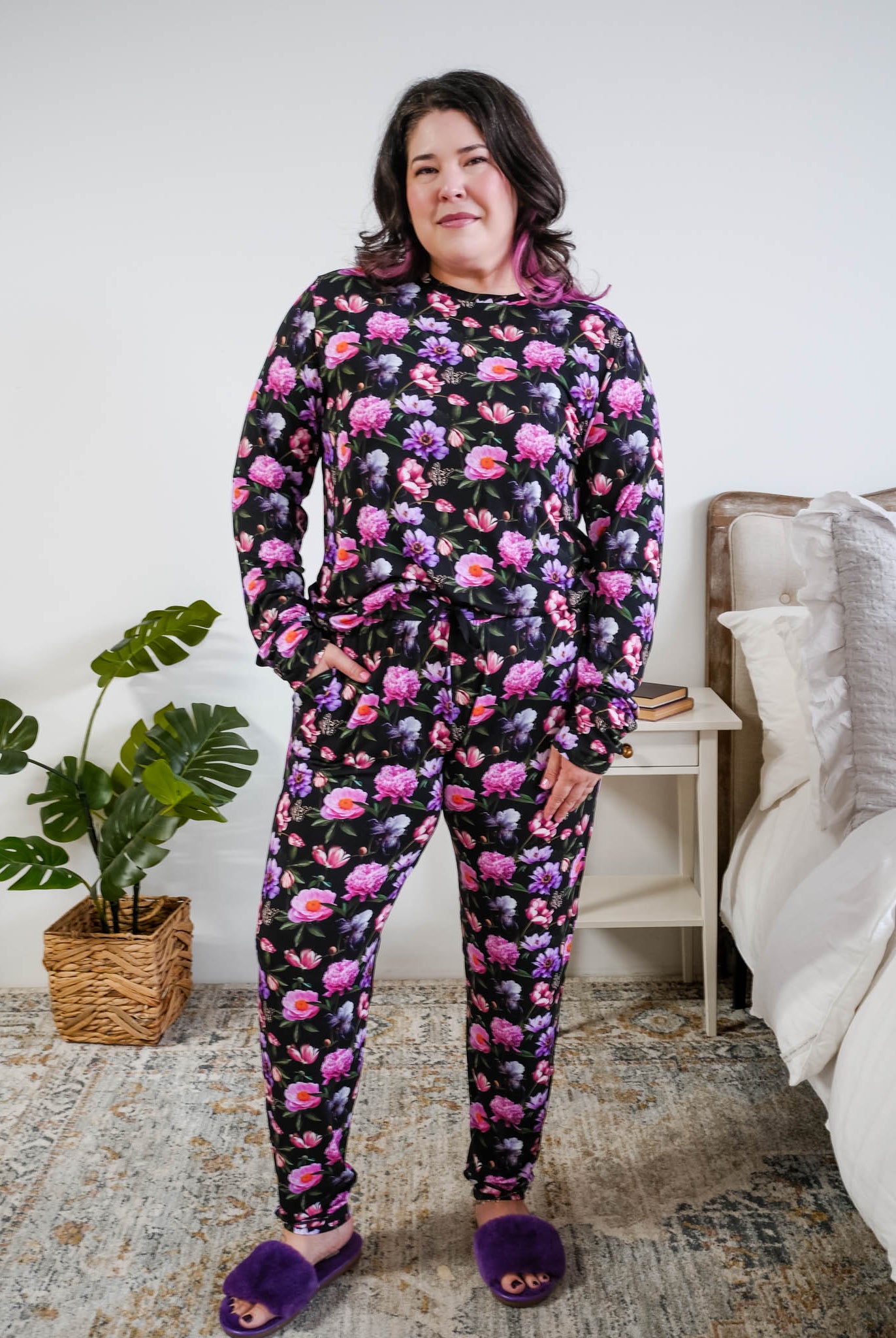 Tucked in view of the pyjama set on a plus size model full length Georgia Rylan women's long sleeve crewneck top and jogger pajama pants set in Dreamy Blooms black floral bamboo Cloud Nine Pajamas