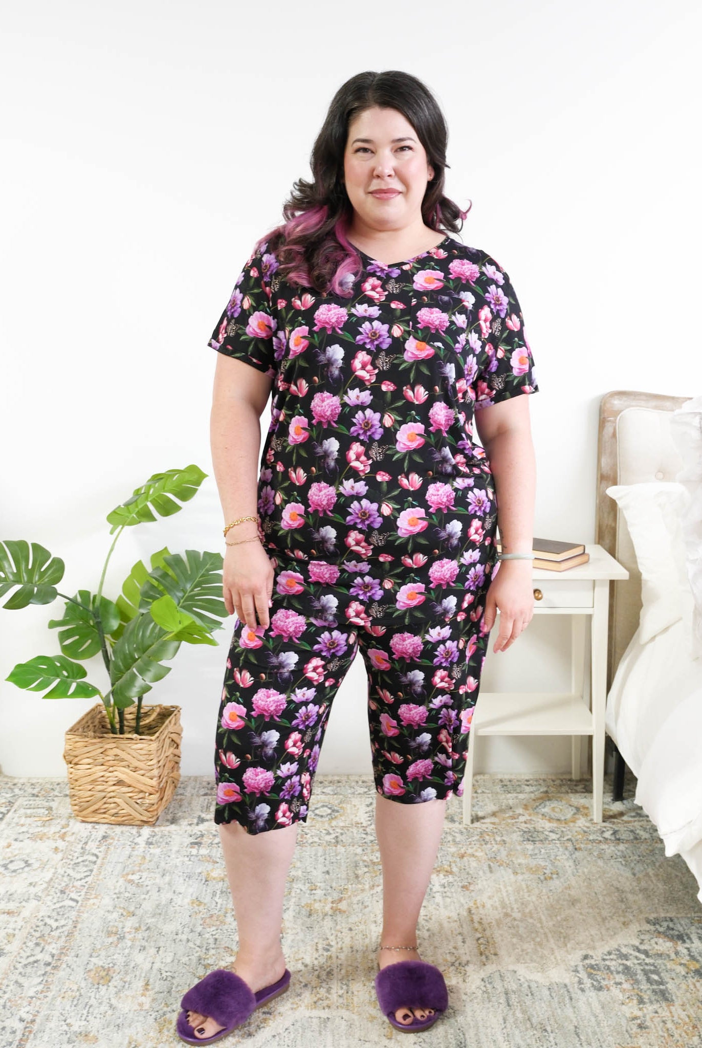 Georgia Rylan women's bamboo rolled-sleeve t-shirt and capri pajama pants in Dreamy Blooms black floral print - Cloud Nine Pajamas Plus Size Model in bedroom setting