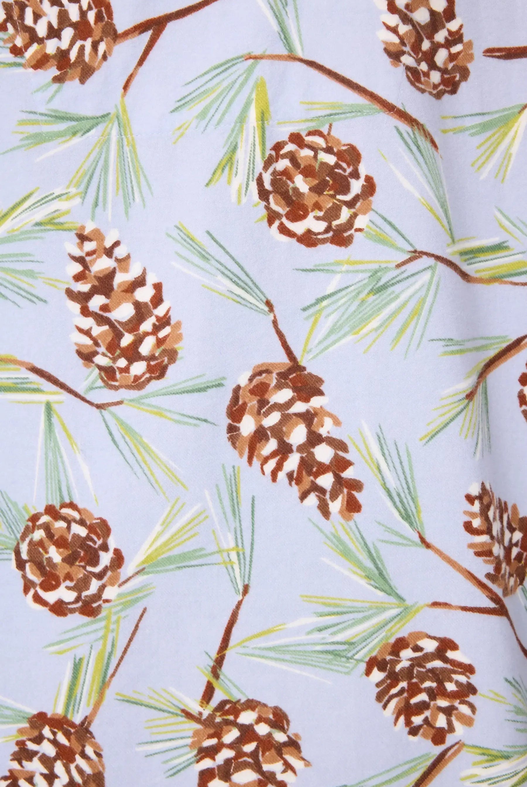 Feelin' Pine fabric pattern featuring pinecones and pine needles on a soft Blue Whisper background.