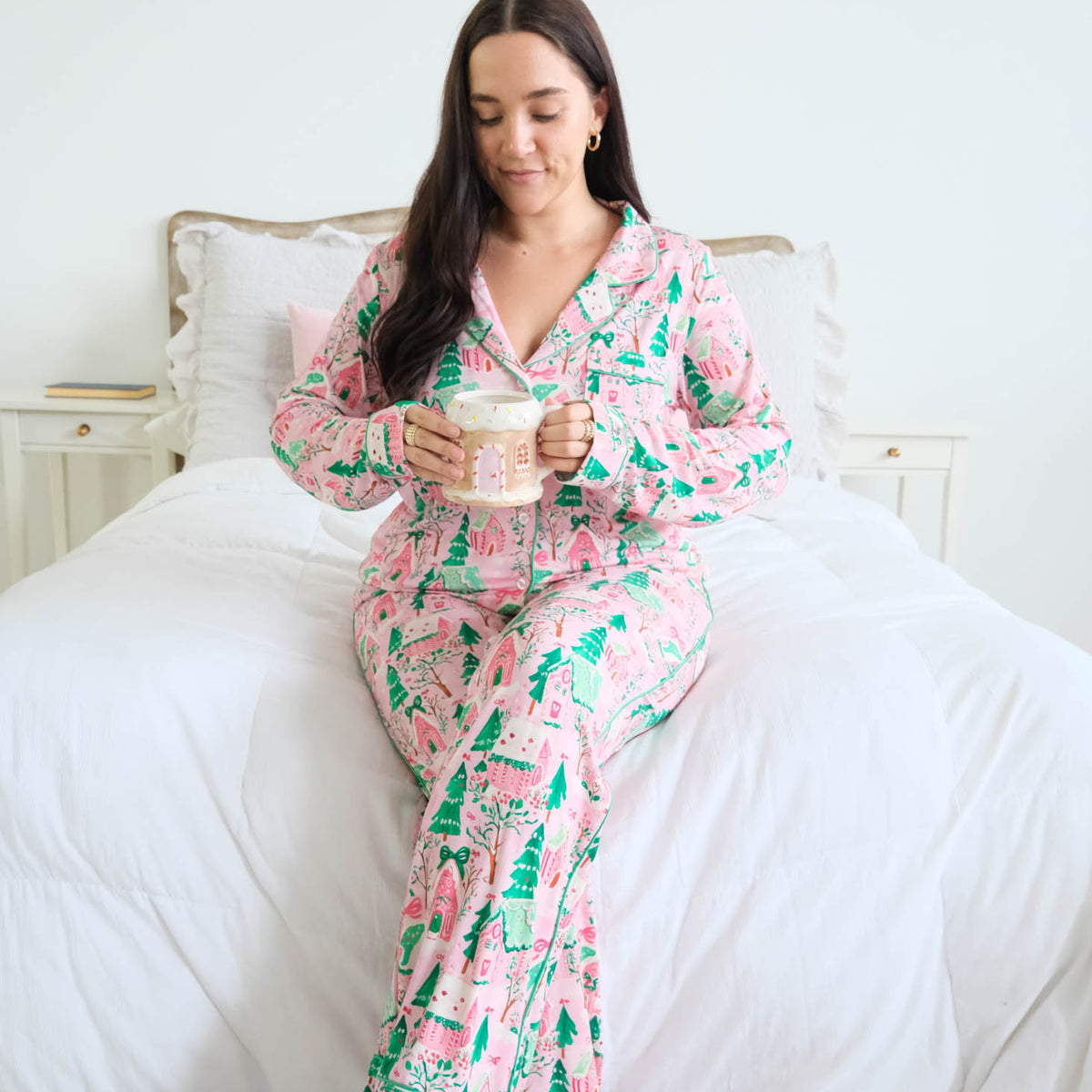 Georgia Rylan Sugar Plum Dreams Bamboo Button-Up PJ Set gingerbread print lifestyle model on bed — Cloud Nine Pajamas Edmonton