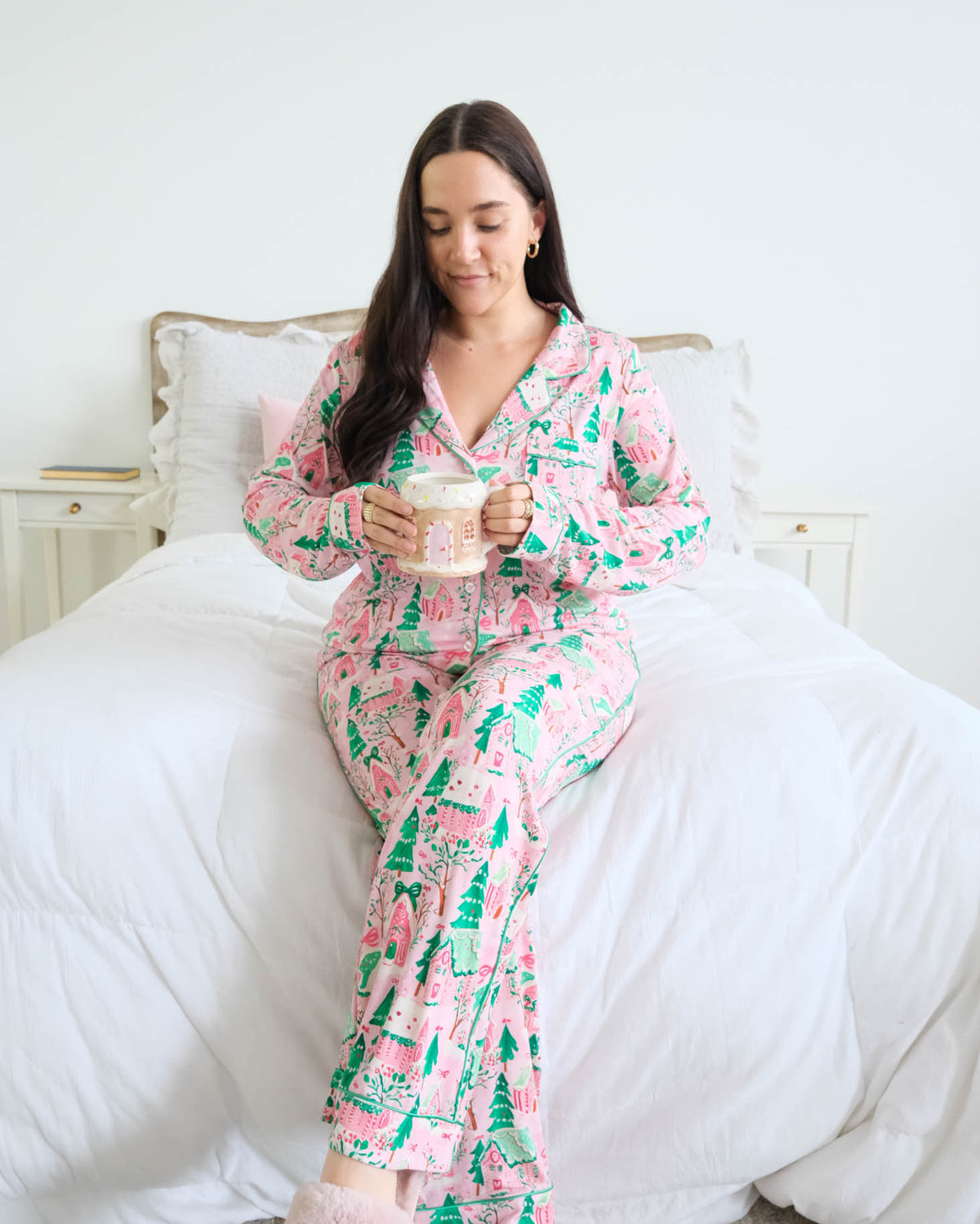 Georgia Rylan Sugar Plum Dreams Bamboo Button-Up PJ Set gingerbread print lifestyle model on bed — Cloud Nine Pajamas Edmonton