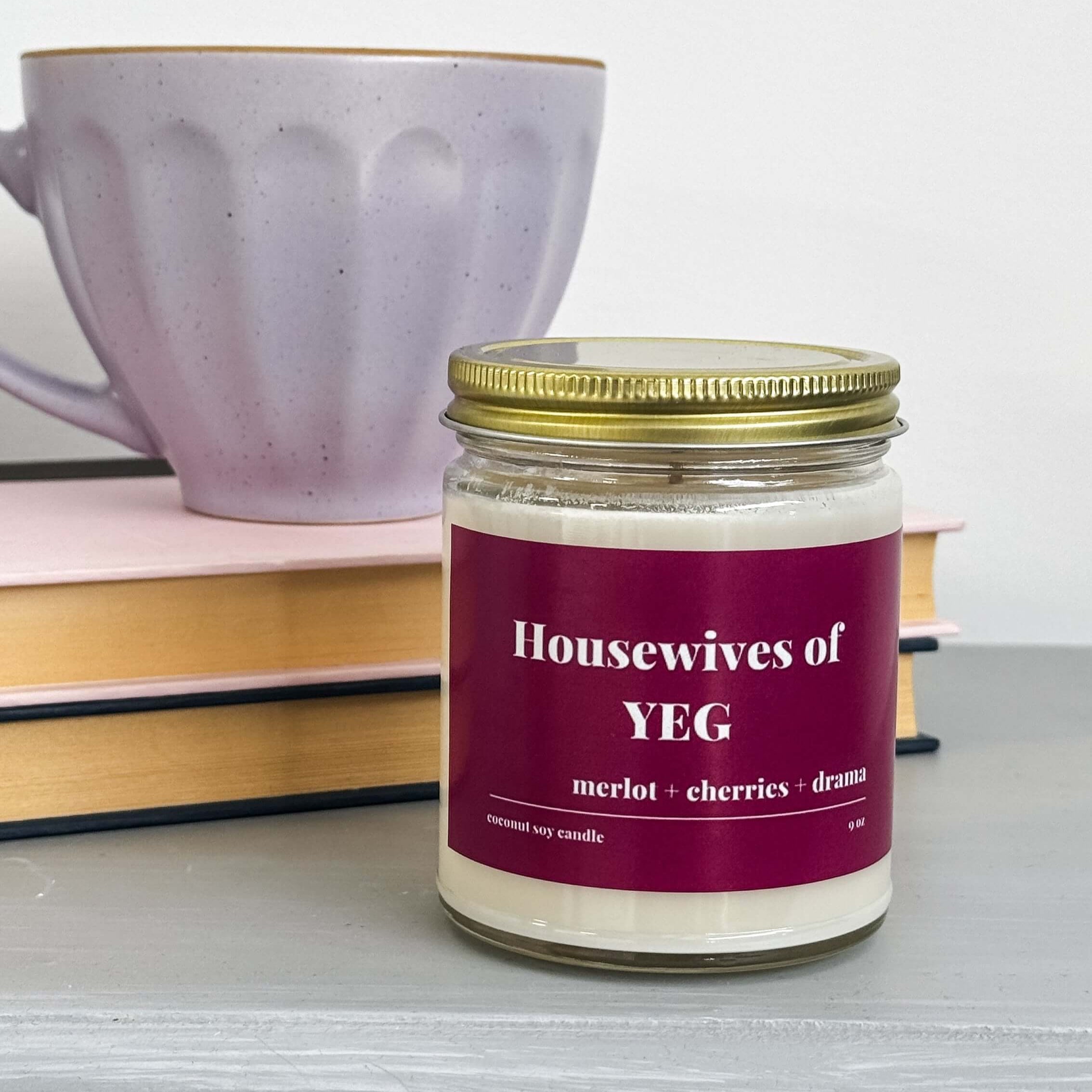 merlot and cherry scented coconut soy wax candle with "Housewives of YEG" label in red