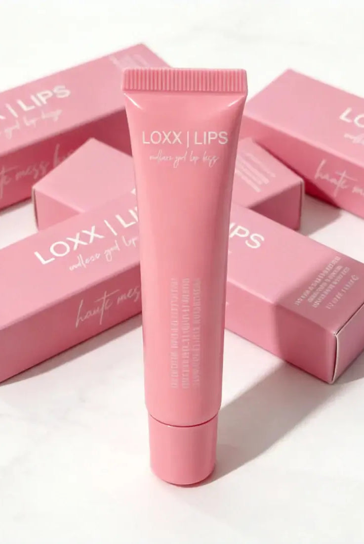 LOXX LIPS Peptide Lip Gloss Haute Mess Kiss Pink Tint packaging and product tube on display.