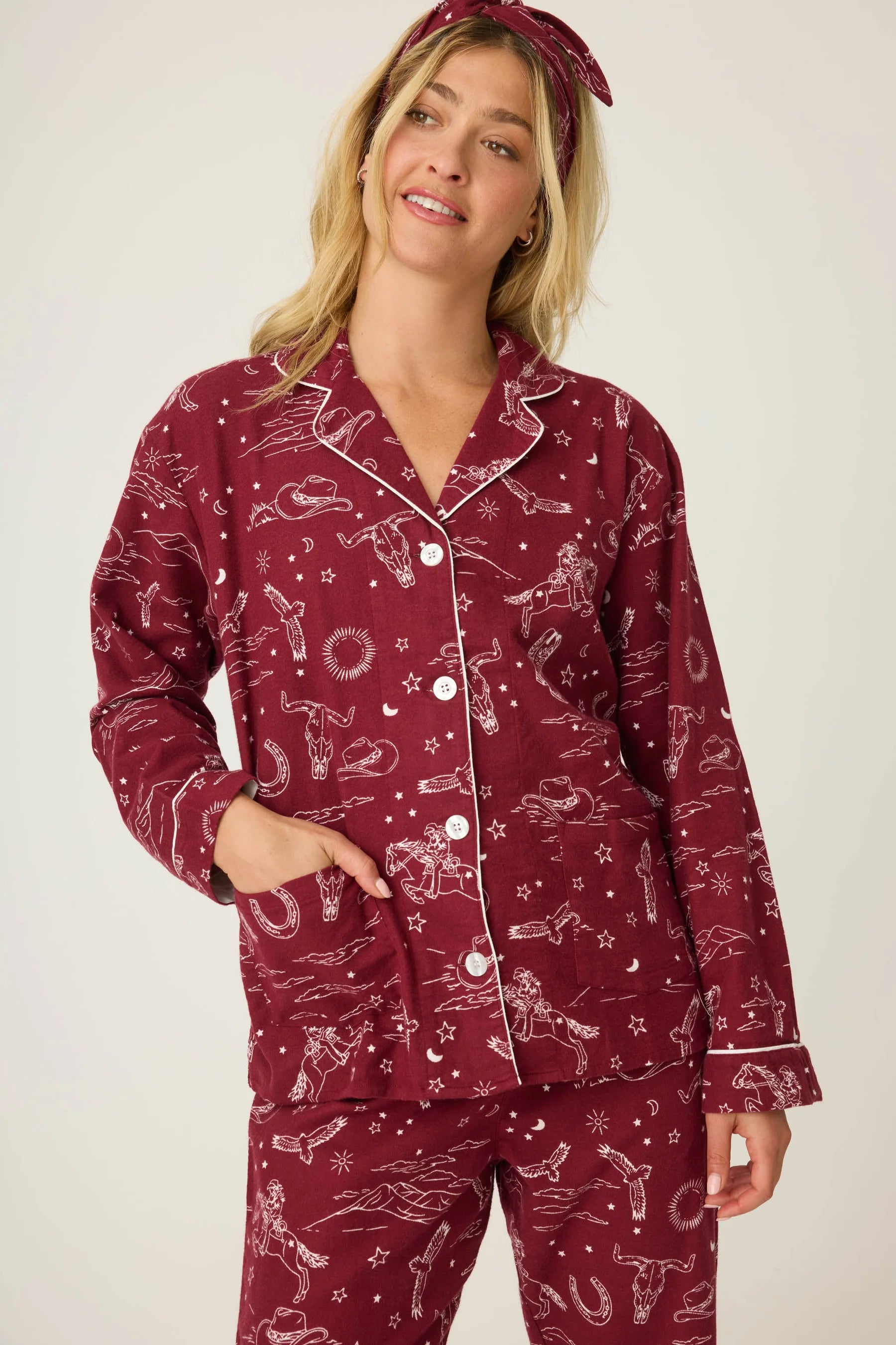 Woman wearing a burgundy pajama set with a white background western horses print pj salvage