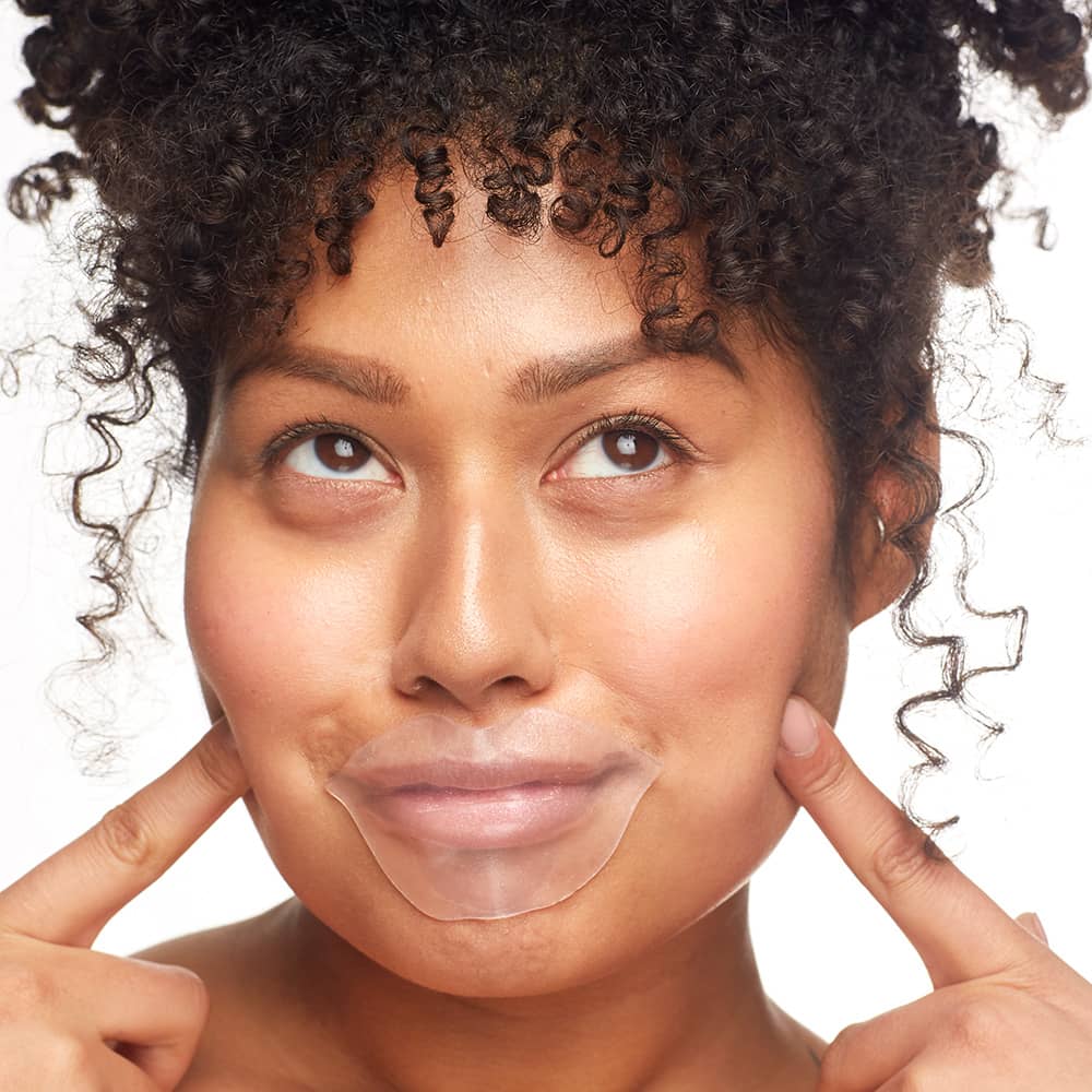 Woman applying Patchology FlashPatch Hydrating Lip Gels for a plump, moisturized pout.