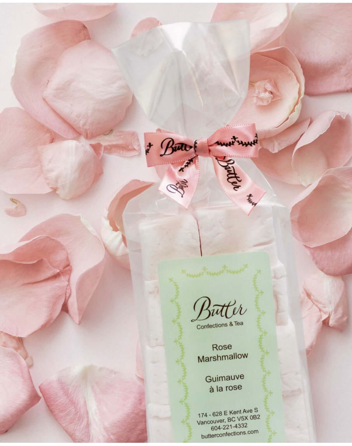 Handcrafted Gourmet Marshmallows in a clear bag with pink rose petals and decorative bow.