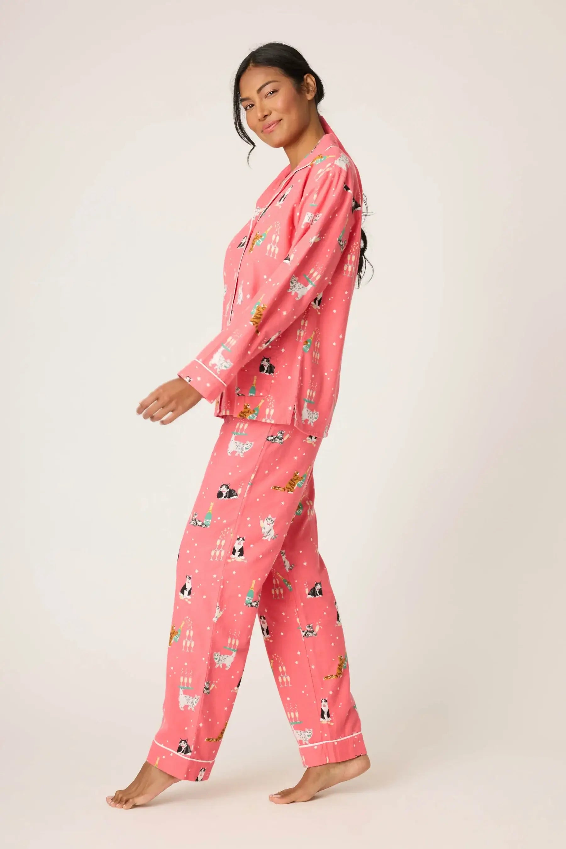 A model wearing the Let's Get Fizzical Flannel 3-Piece PJ Set by PJ Salvage in dark coral with fun cat print.