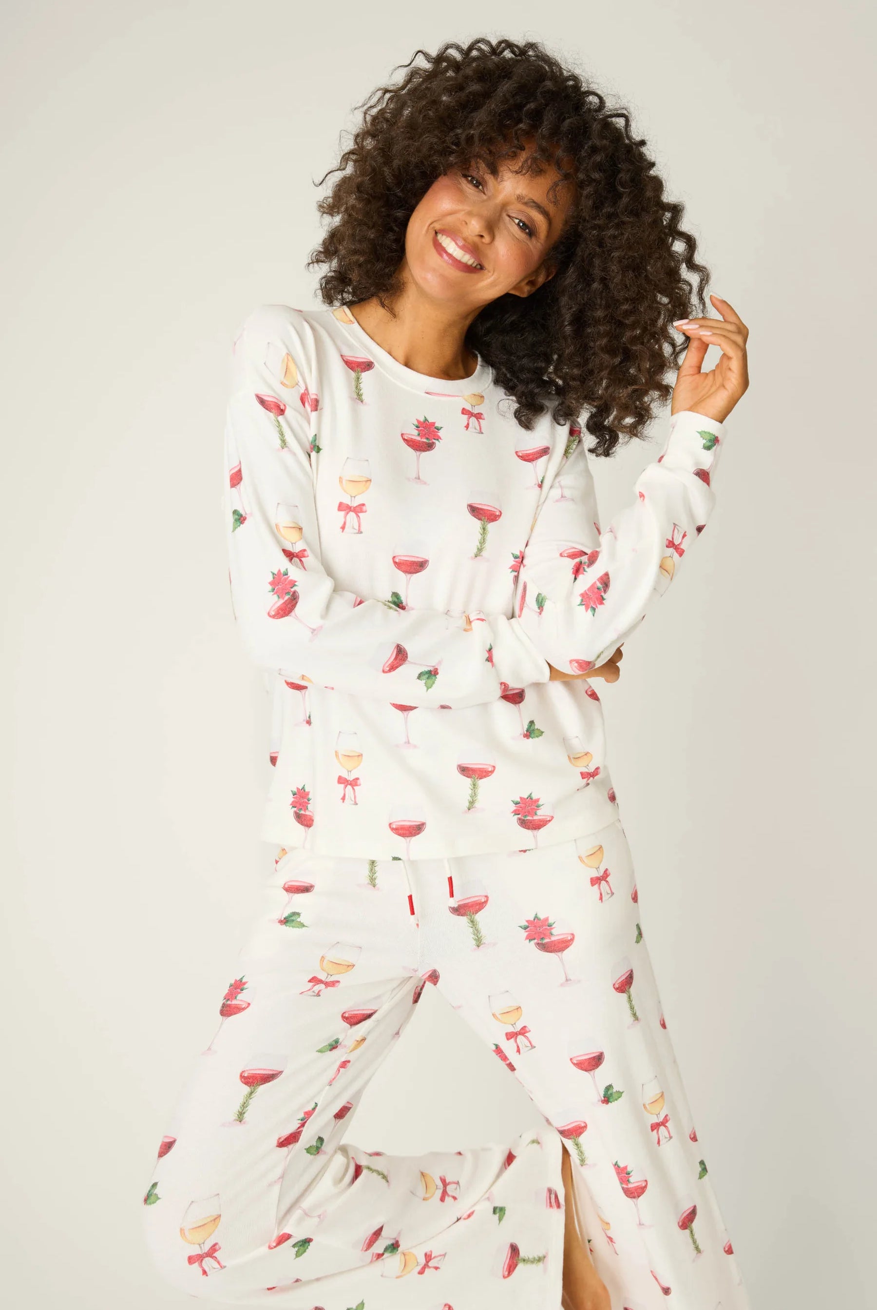 Let's Get Toasty Holiday Wine Print PJ Set | Champagne | PJ Salvage Women's set with champagne coupes with red liquid and holly, poinsettia and bows on an ivory background