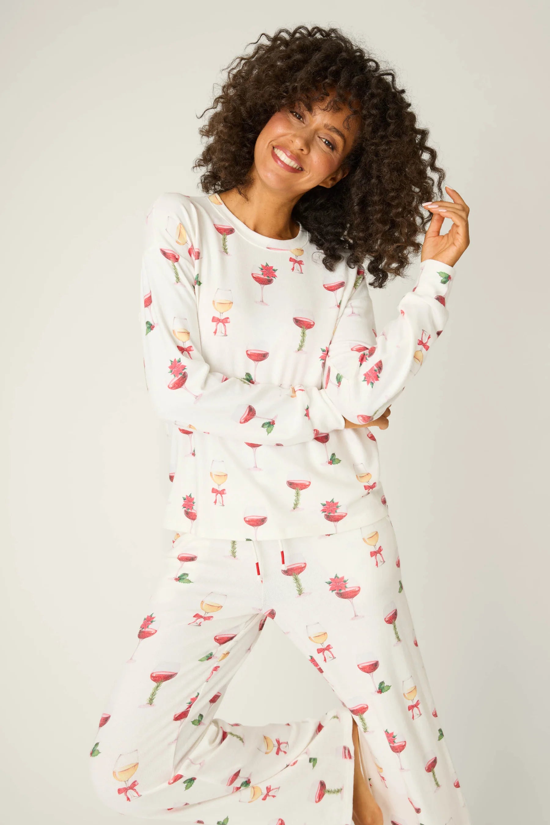 Let's Get Toasty Holiday Wine Print PJ Set | Champagne | PJ Salvage Women's set with champagne coupes with red liquid and holly, poinsettia and bows on an ivory background