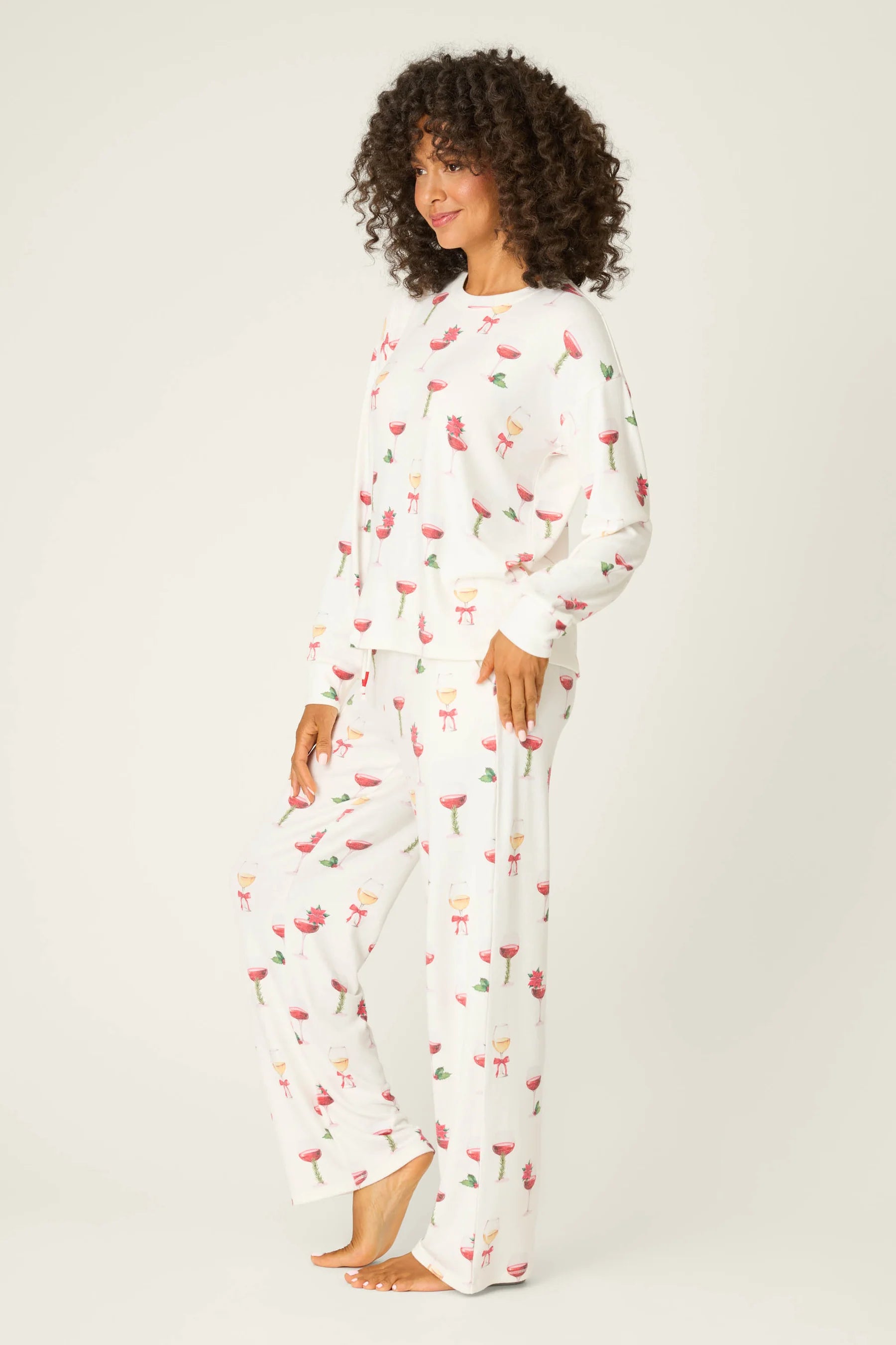 Let's Get Toasty Holiday Wine Print PJ Set | Champagne | PJ Salvage Women's set with champagne coupes with red liquid and holly, poinsettia and bows on an ivory background