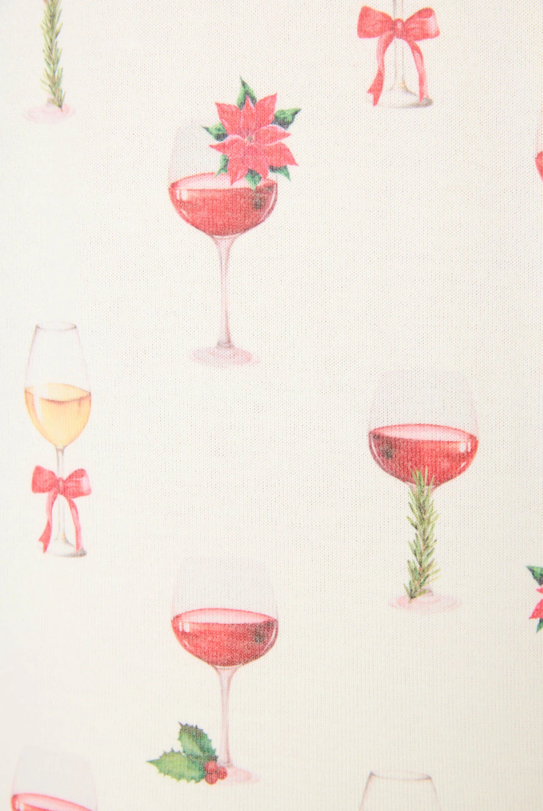 Let's Get Toasty Holiday Wine Print PJ Set | Champagne | PJ Salvage Women's set close up of print with champagne coupes with red liquid and holly, poinsettia and bows on an ivory background