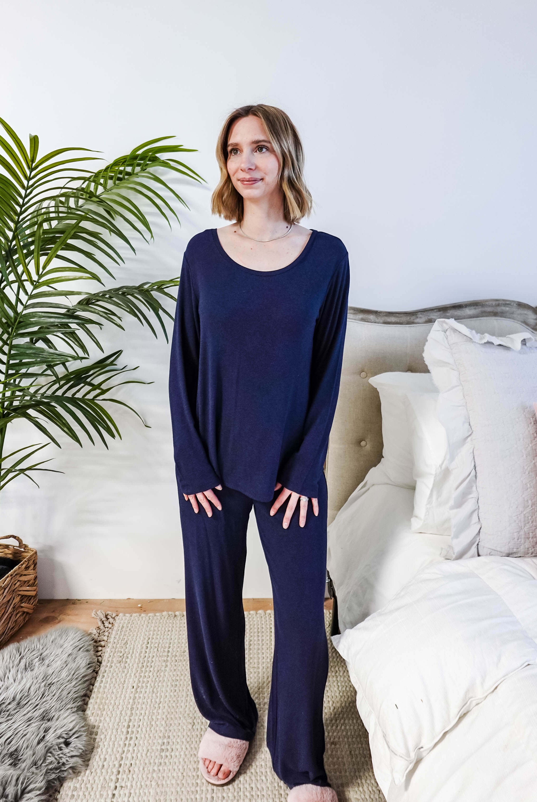 Miranda wearing the Navy Melange Top Straight Pant Knit Lounge Set, highlighting the boat-neck top and flowy trousers.
Showing shirt untucked from pants and the shape