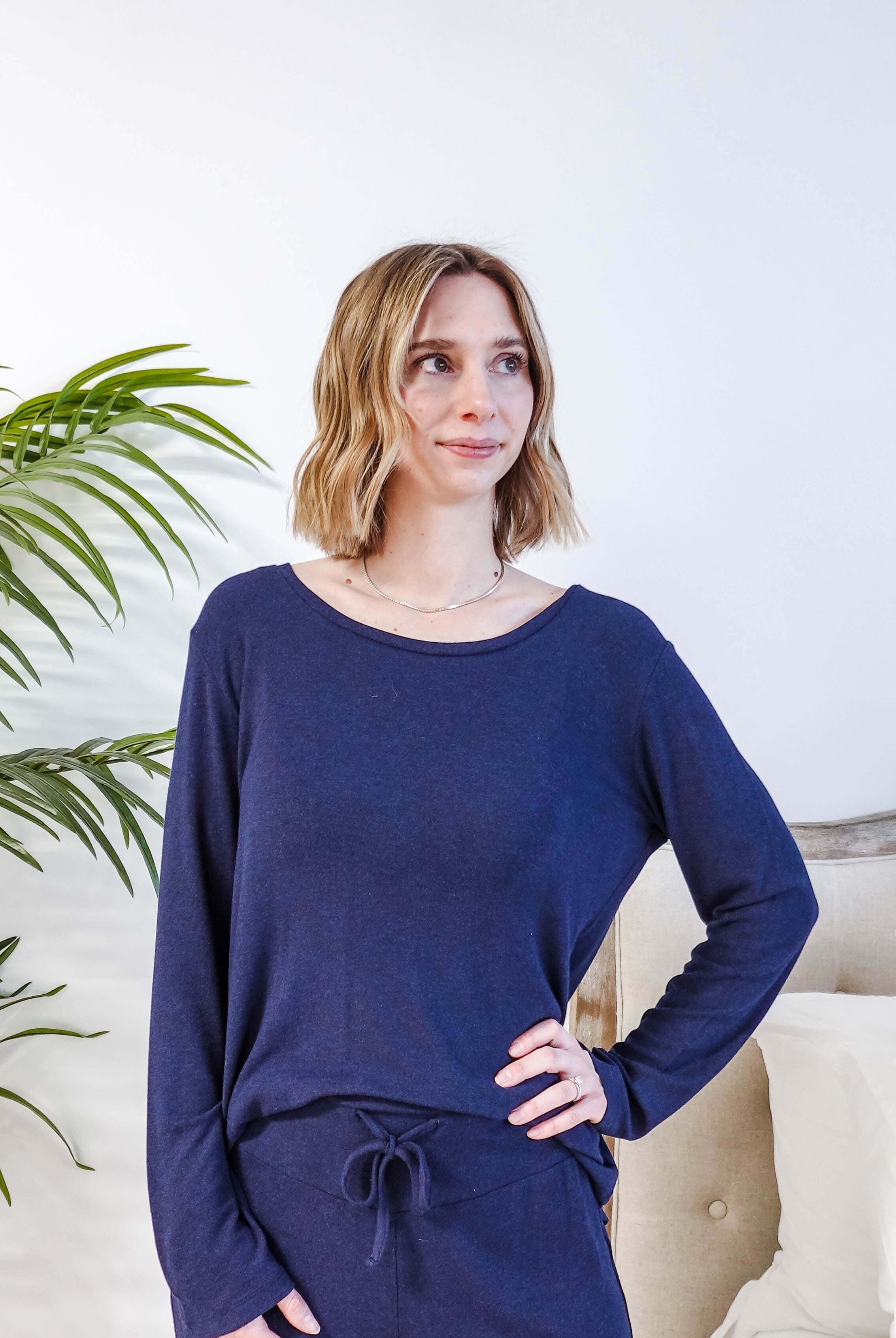Miranda wearing the Navy Melange Top Straight Pant Knit Lounge Set, highlighting the boat-neck top and flowy trousers.
Showing the drawstring and wide waistband on the pants