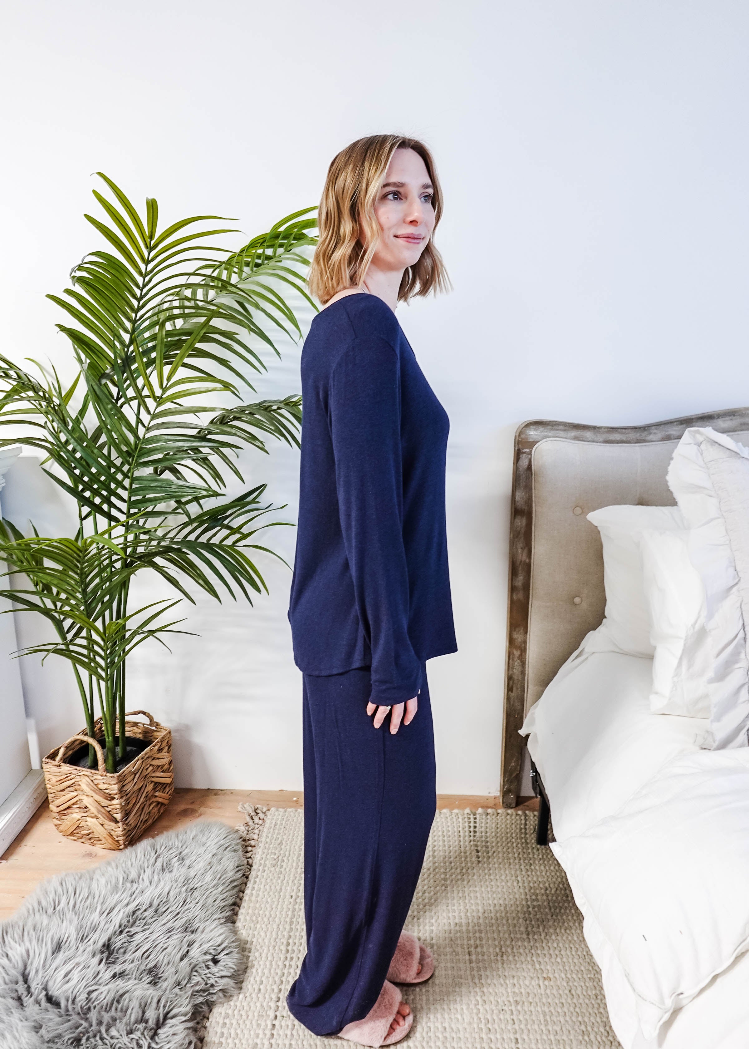 Miranda wearing the Navy Melange Top Straight Pant Knit Lounge Set, highlighting the boat-neck top and flowy trousers.
Side profile shot