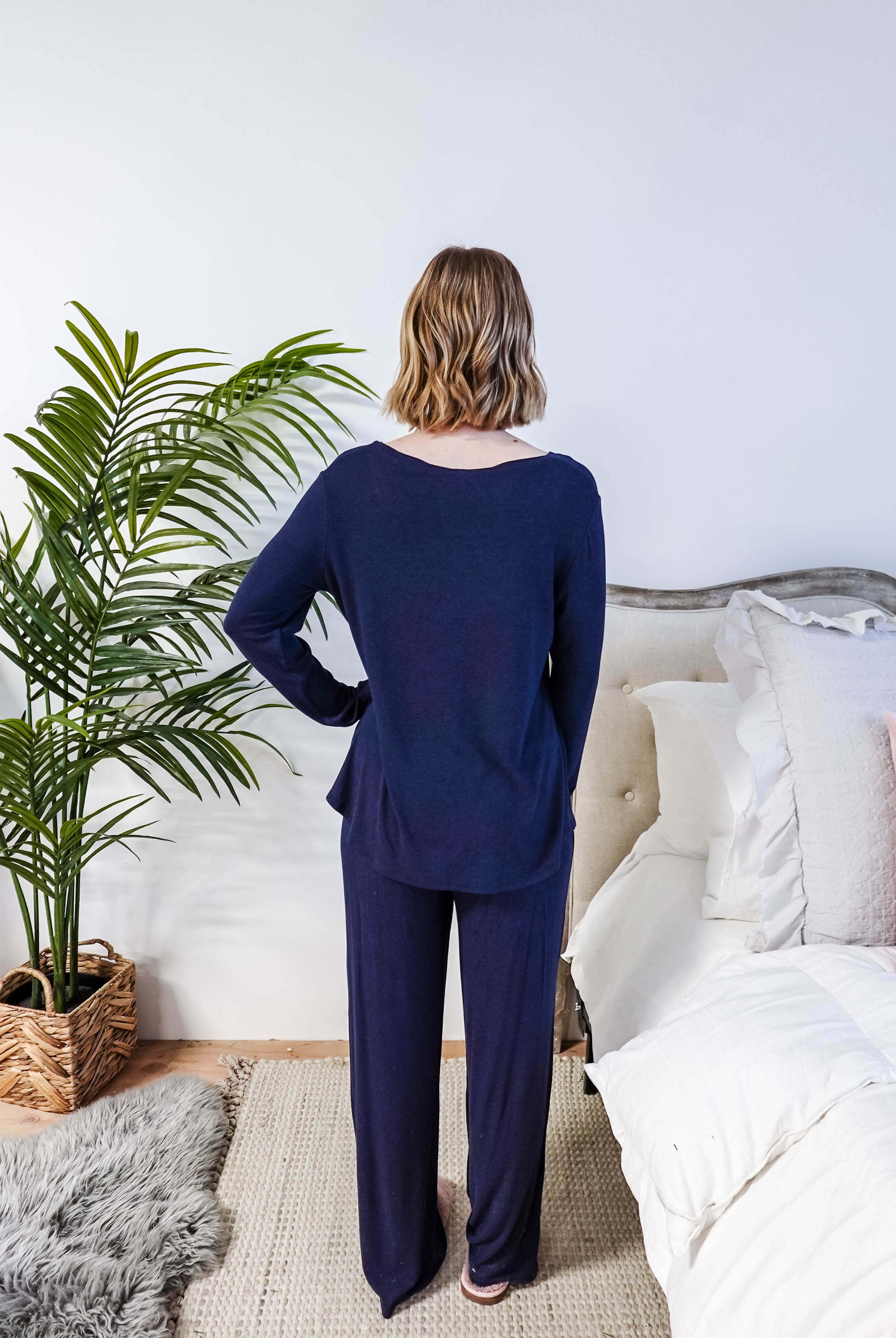 Miranda wearing the Navy Melange Top Straight Pant Knit Lounge Set, highlighting the boat-neck top and flowy trousers.
Shot showing fit from the back
